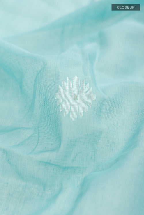 Close up of Turquoise Bengal Cotton Saree with Jamdani on the body and Zari Border displaying folds