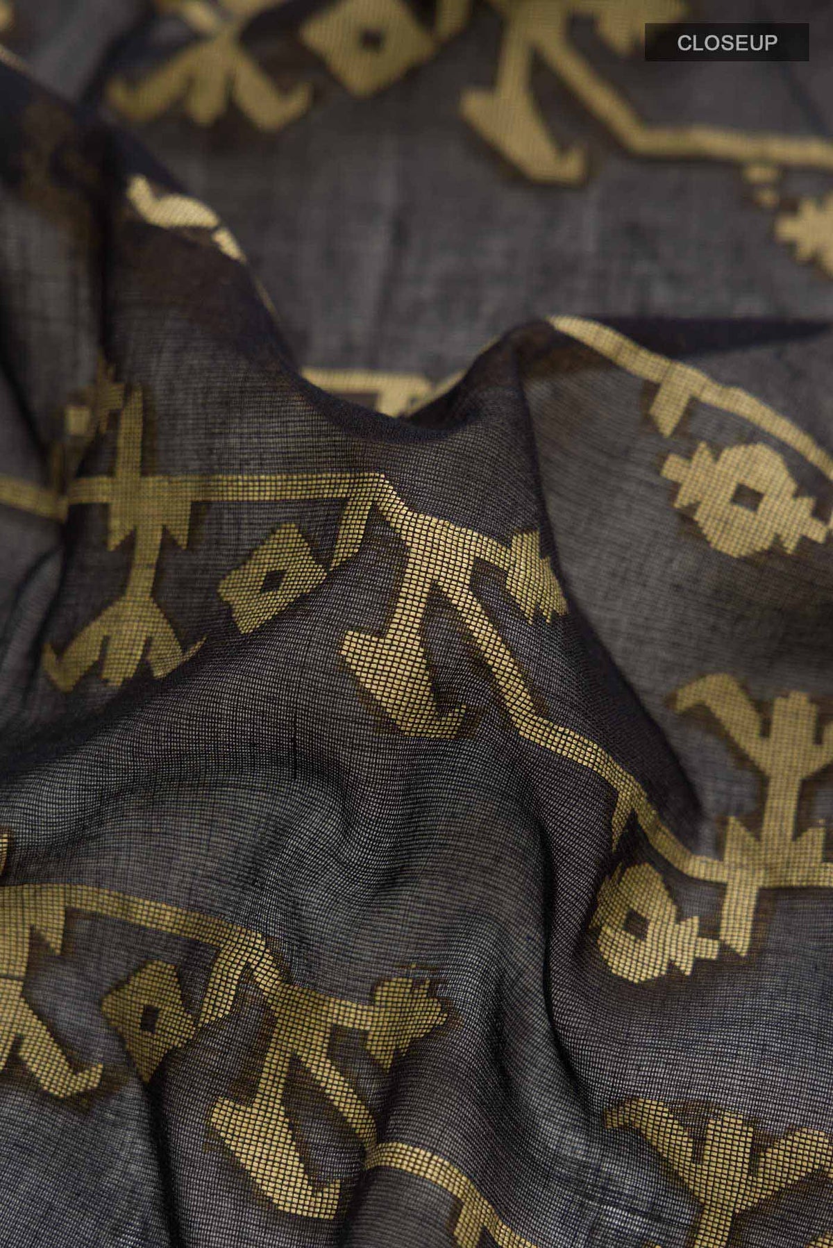 Close up of Black Bengal Cotton Saree with Jamdani on the body and Zari Border displaying folds