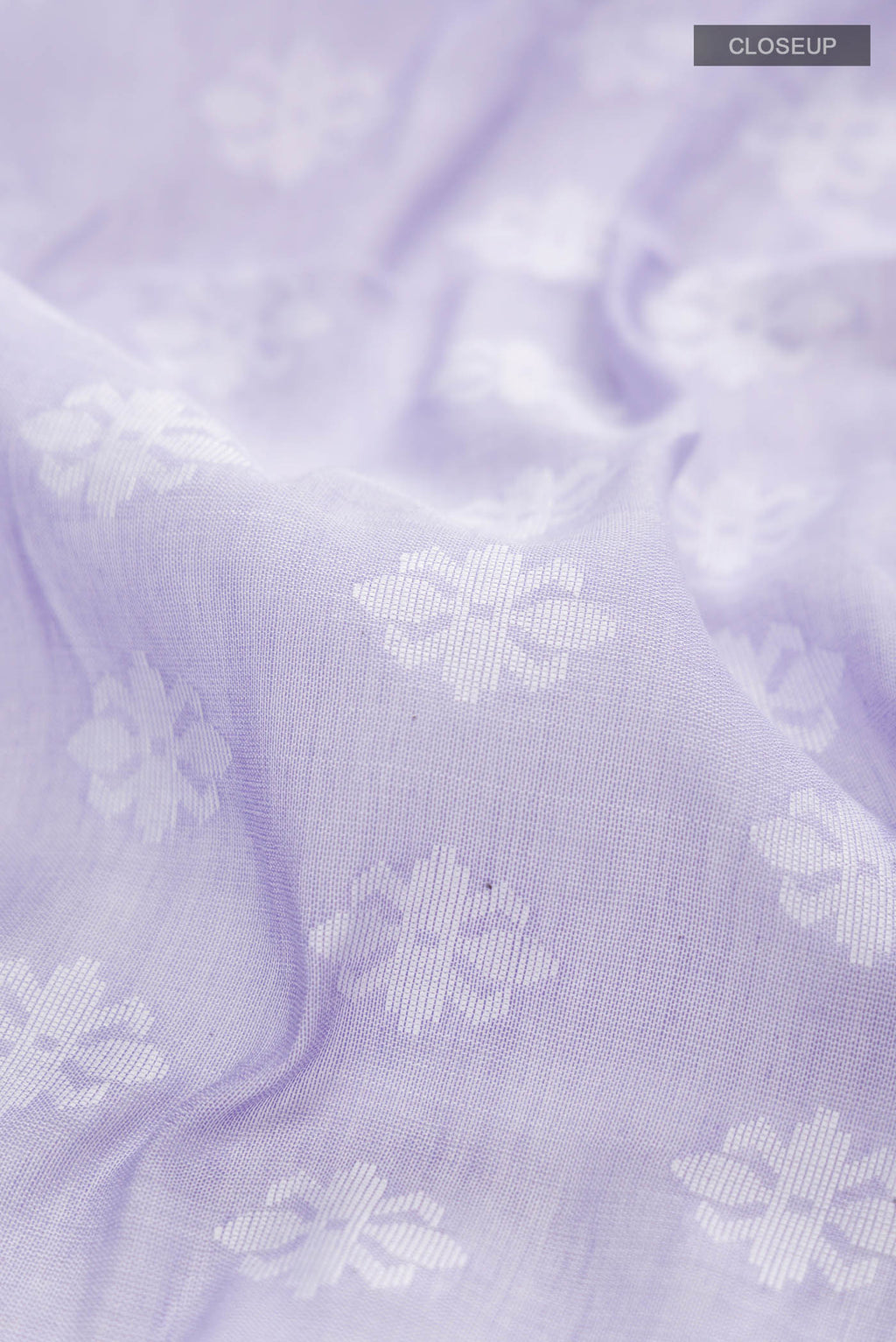 Close up of Lavender Bengal Cotton Saree with Jamdani on the body and Thread Border displaying folds