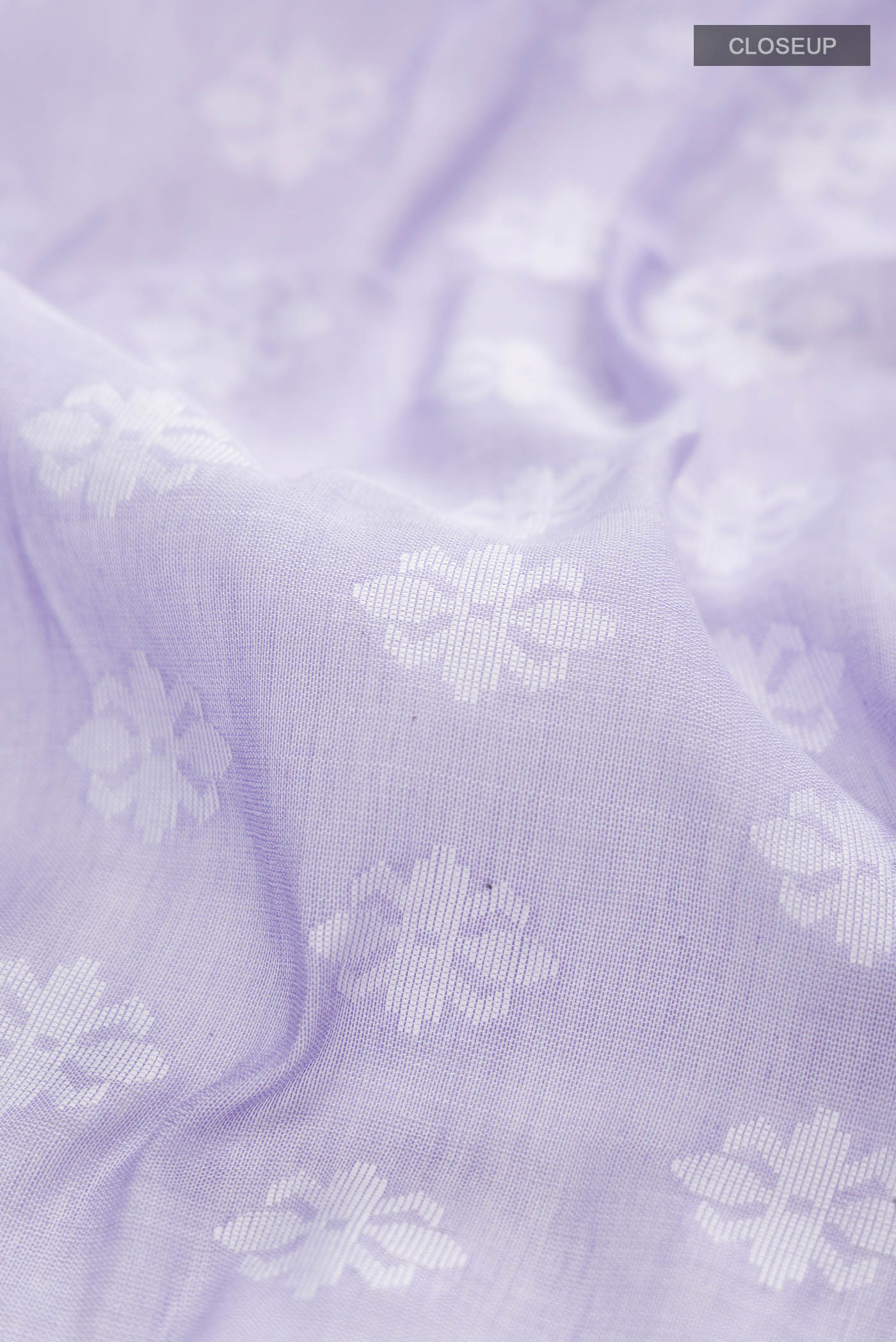 Close up of Lavender Bengal Cotton Saree with Jamdani on the body and Thread Border displaying folds
