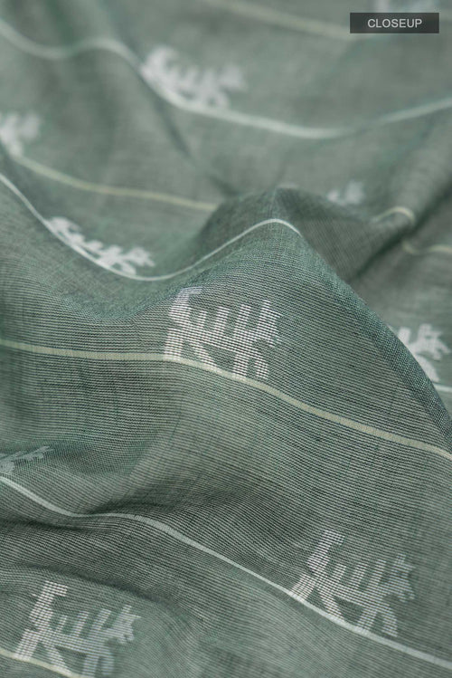 Close up of Green Bengal Cotton Saree with Jamdani on the body and Thread Border displaying folds