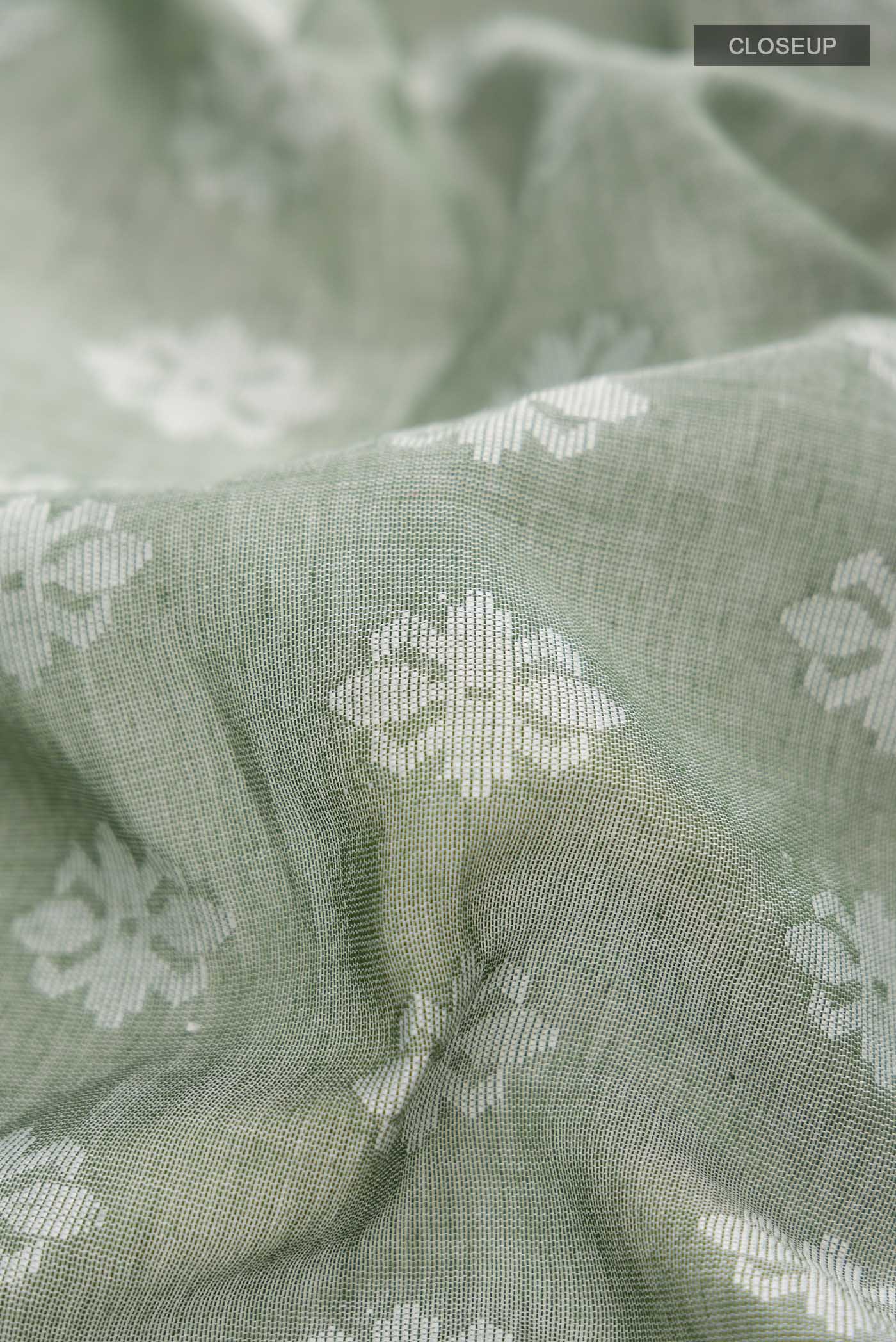 Close up of Olive Green Bengal Cotton Saree with Jamdani on the body and Thread Border displaying folds