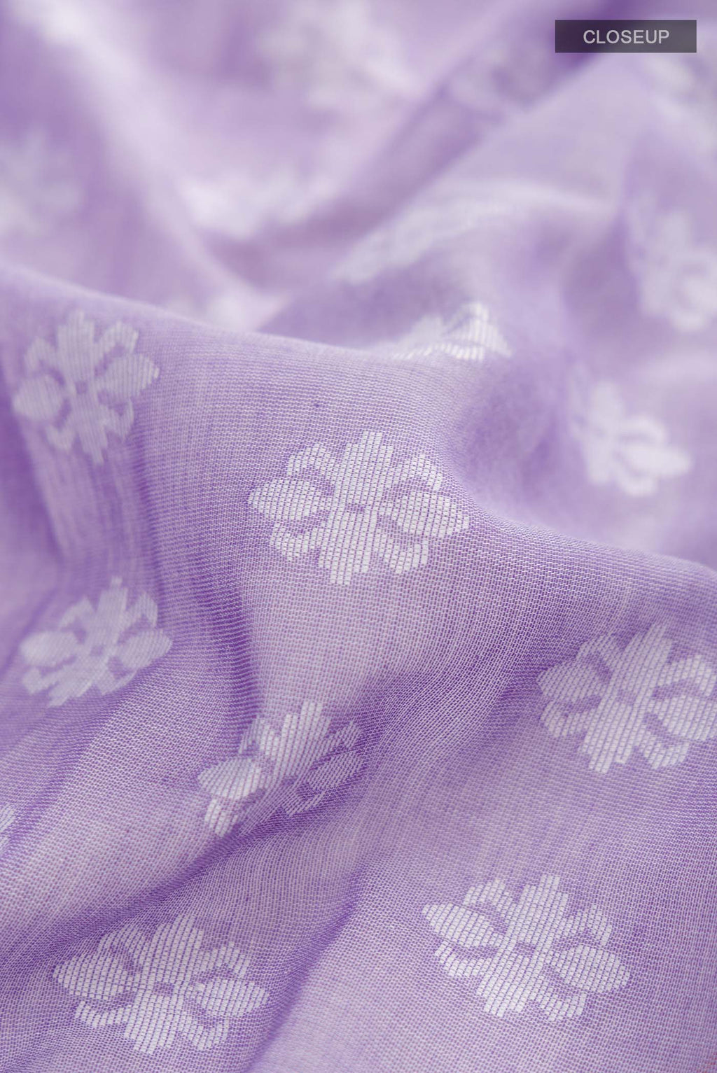 Close up of Lavender Bengal Cotton Saree with Jamdani on the body and Thread Border displaying folds
