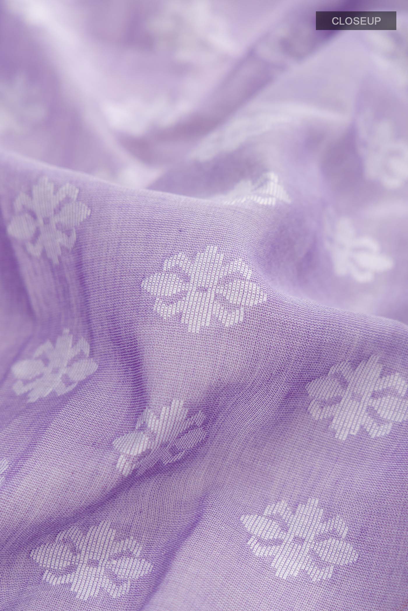 Close up of Lavender Bengal Cotton Saree with Jamdani on the body and Thread Border displaying folds