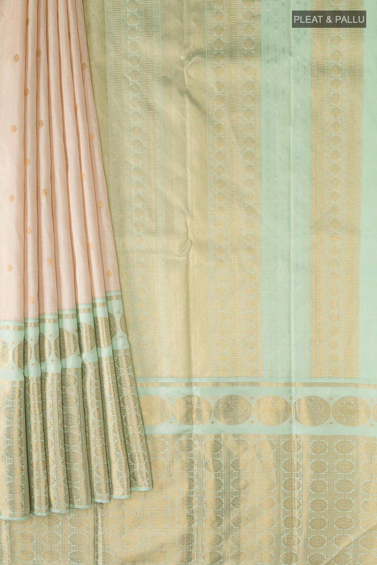 Pleats and pallu of Cream Kanchipuram Silk Saree with Zari Butta on the body and Zari Border
