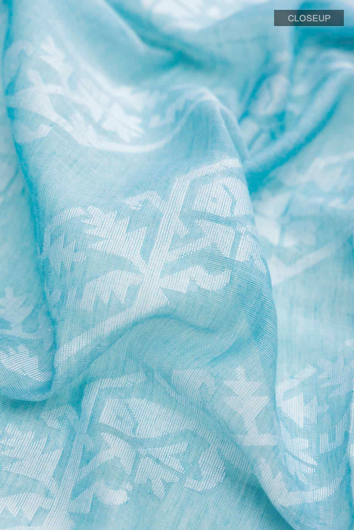 Close up of Light Blue Bengal Cotton Saree with Jamdani on the body and Thread Border displaying folds