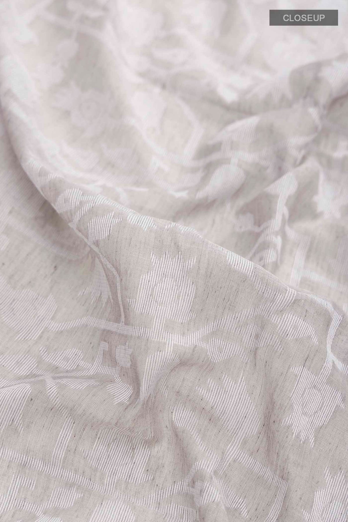 Close up of Grey Bengal Cotton Saree with Jamdani on the body and Plain Border displaying folds
