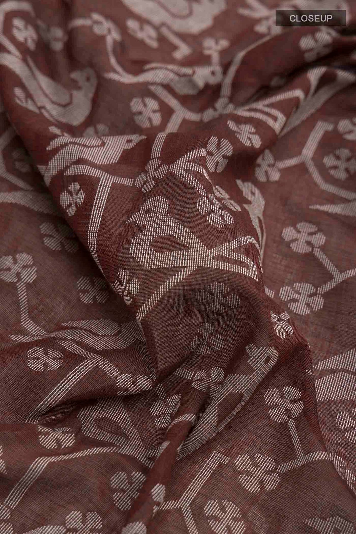 Close up of Brown Bengal Cotton Saree with Jamdani on the body and Thread Border displaying folds