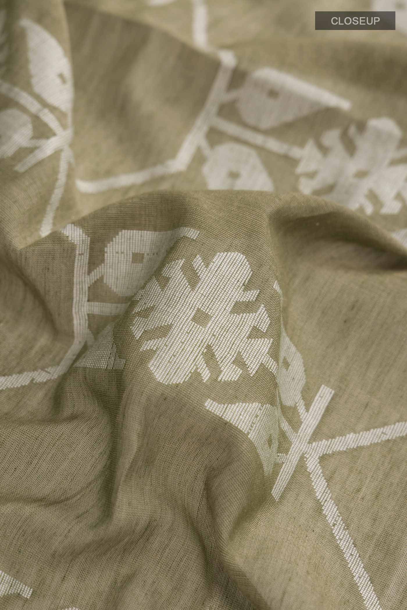 Close up of Green Bengal Cotton Saree with Jamdani on the body and Zari Border displaying folds