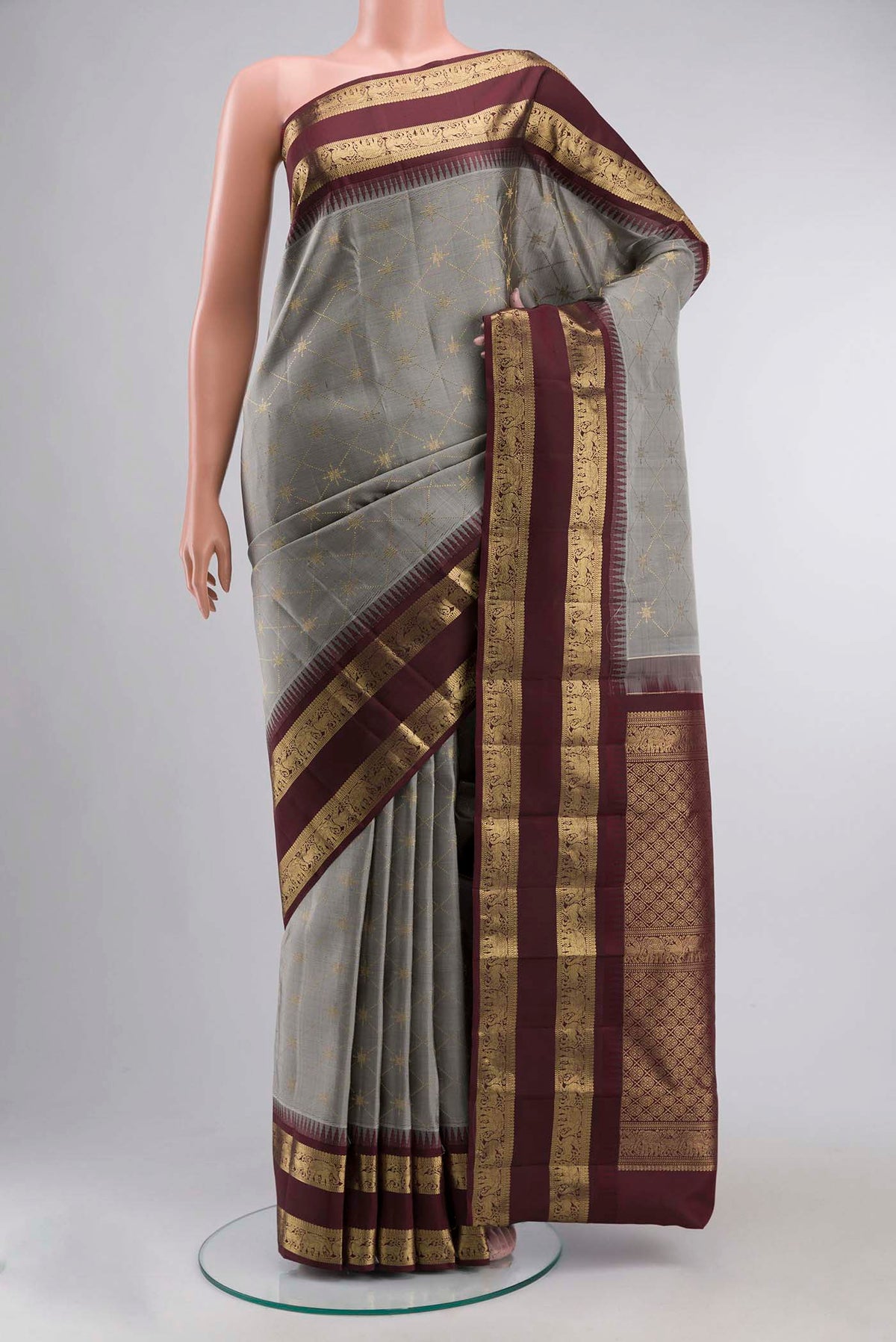 Grey Kanchipuram Silk Saree with Zari Butta on the body and Zari Border displayed on a mannequin