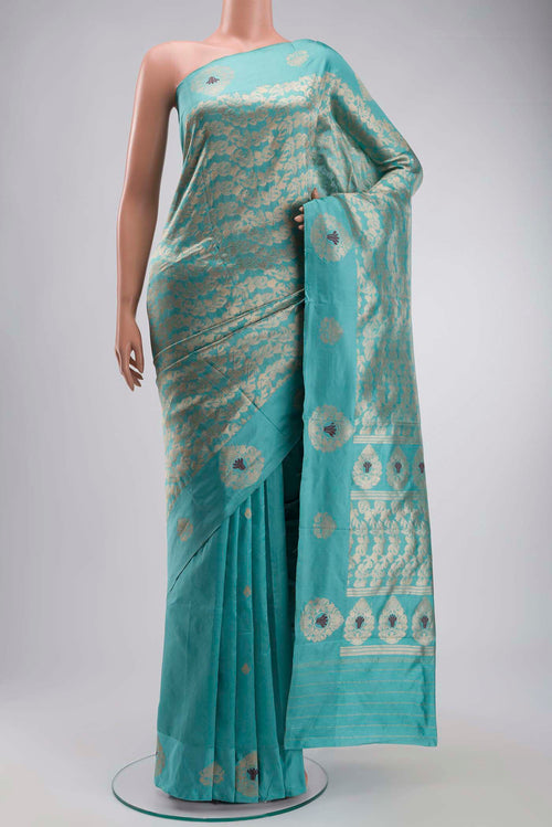 Turquoise Banarasi Katan Silk Saree with Zari Butta on the body and Zari Border displayed on a mannequin