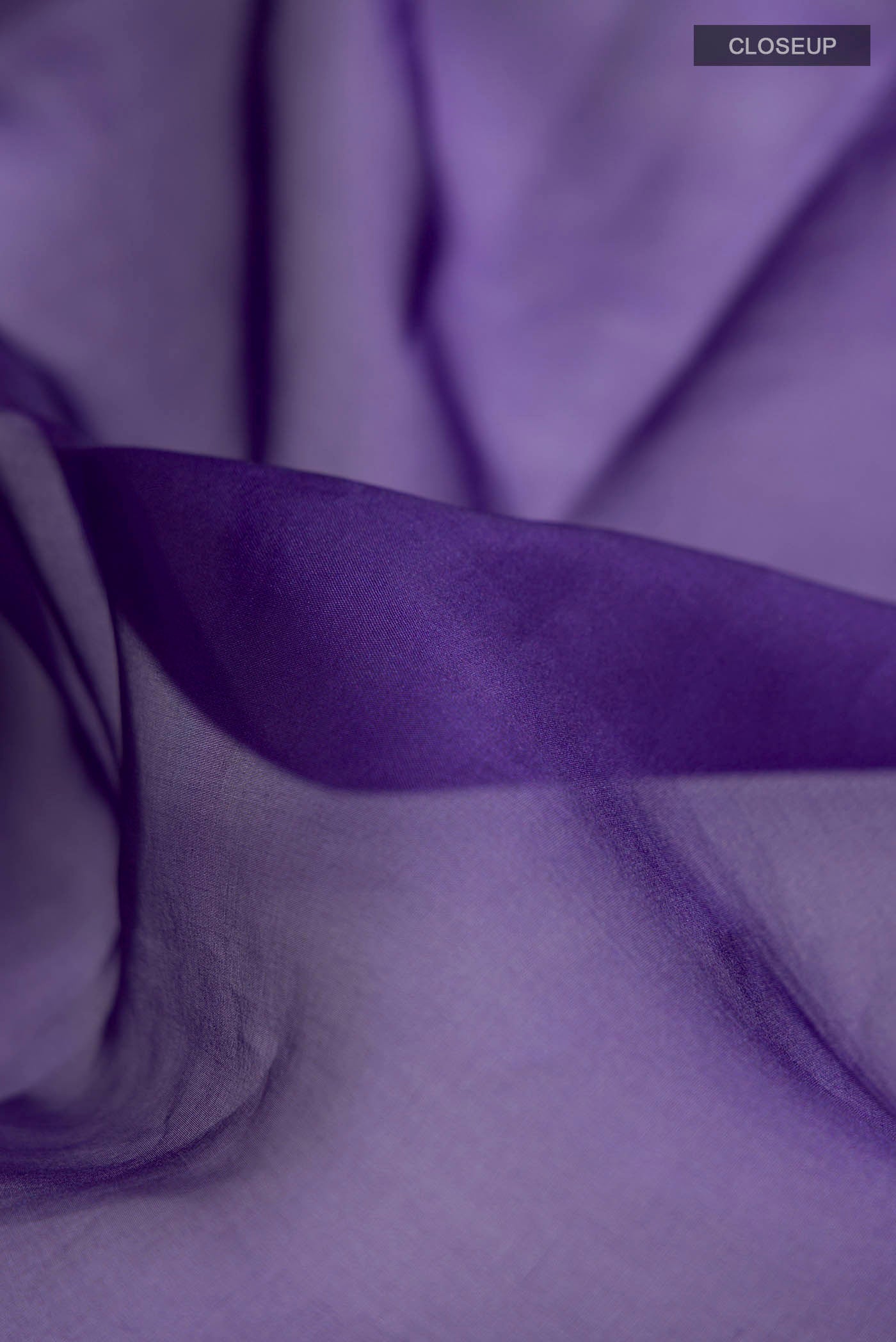 Close up of Navy Blue Organza Silk Saree with Plain Body and Embroidery Border displaying folds