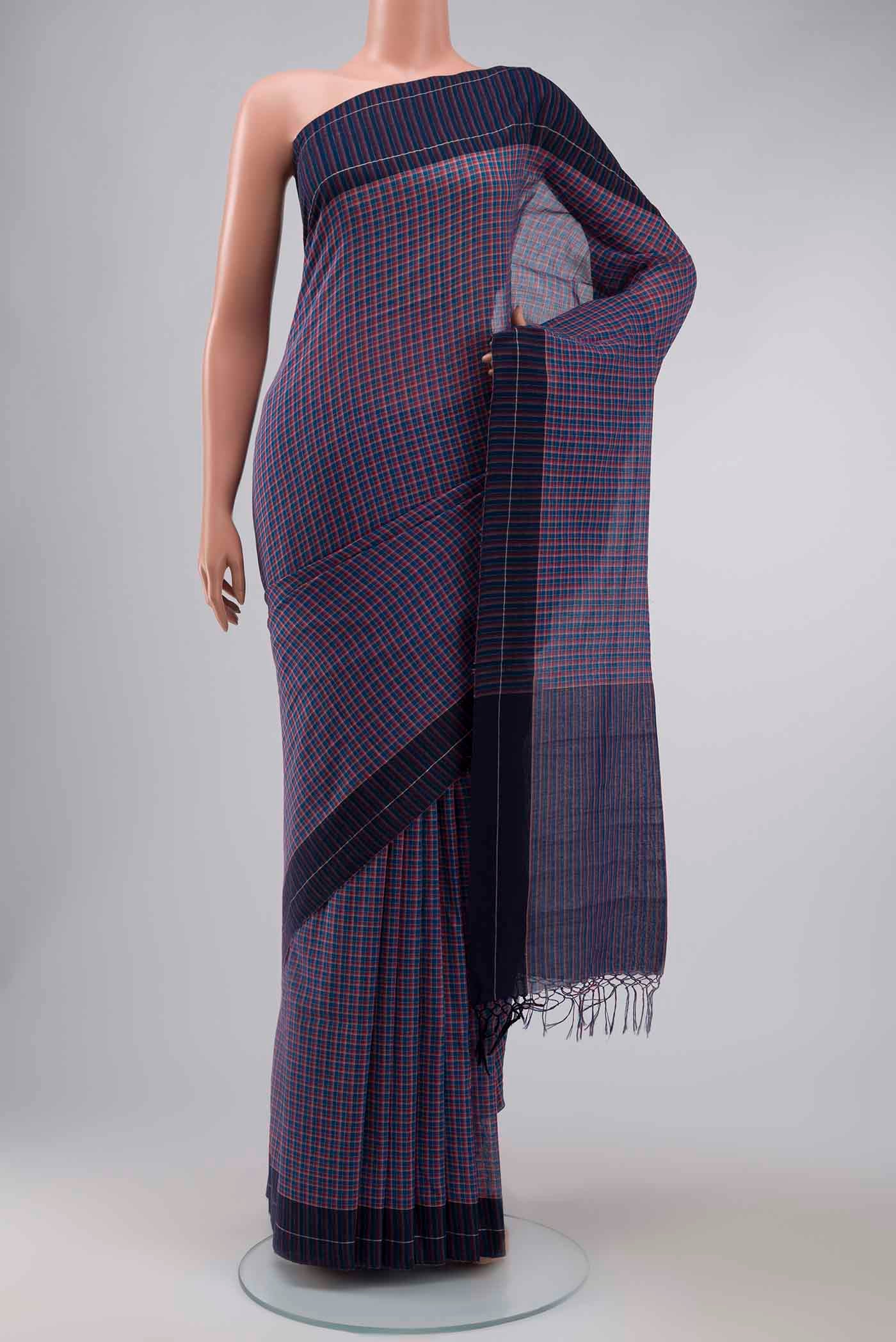 Patang features fine multi-coloured checks woven using four harmonious hues, creating a lively yet balanced design Translating to ?te)n Hindi, the saree reflects the light, easy spirit of a patang gliding across an open sky The border and pallu are minimal, finished with delicate zari accents that add subtle richness With its balanced play of colour, it makes for a breathable, comfortable drape displayed on a mannequin