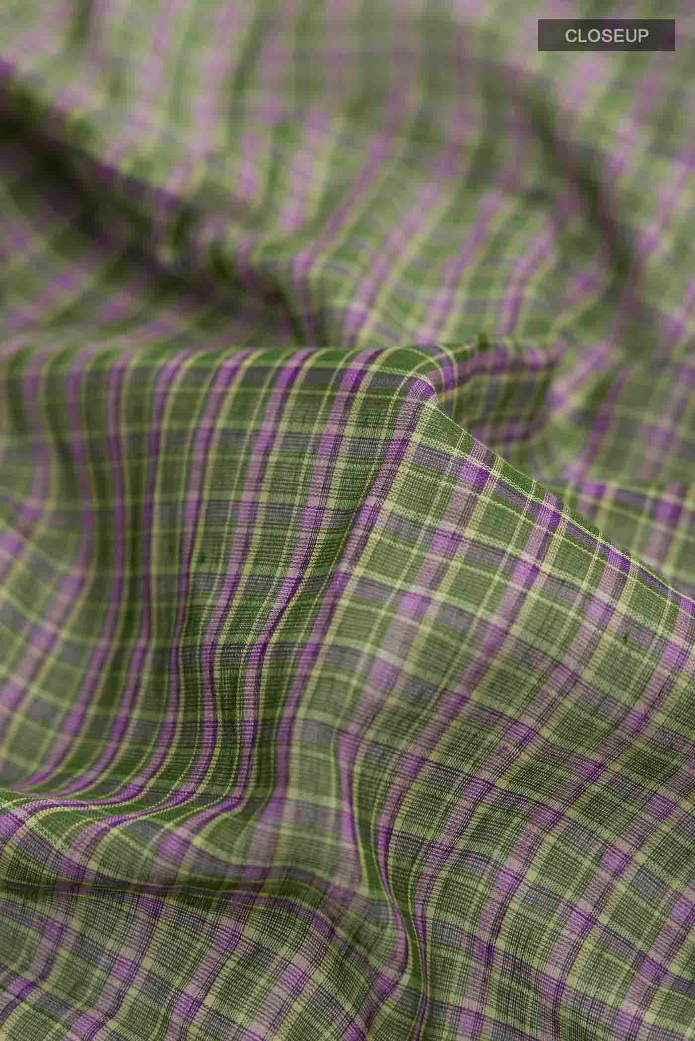Close up of Patang features fine multi-coloured checks woven using four harmonious hues, creating a lively yet balanced design Translating to ?te)n Hindi, the saree reflects the light, easy spirit of a patang gliding across an open sky The border and pallu are minimal, finished with delicate zari accents that add subtle richness With its balanced play of colour, it makes for a breathable, comfortable drape displaying folds