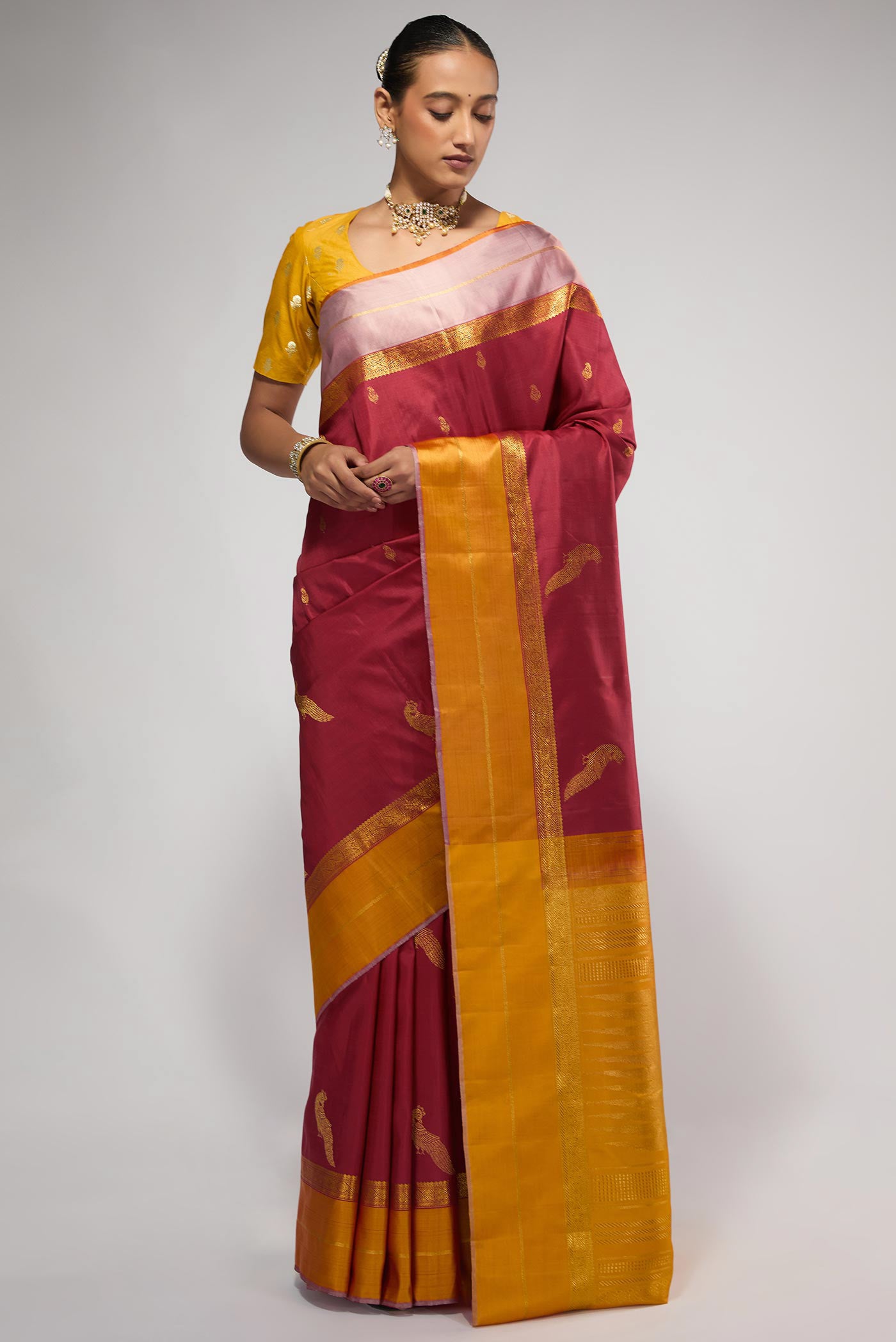 Pure Silk Pure Zari Maroon Kanchipuram Saree with Zari Butta on the body and Zari Border displayed on a mannequin