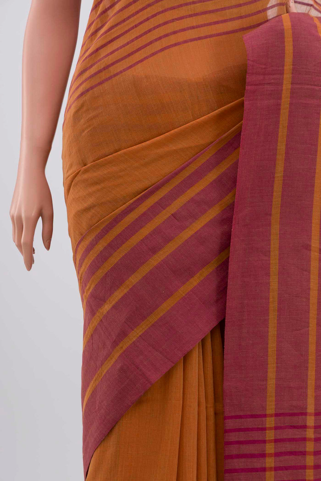 Border image of Titli, framed with proportioned stripes that gradually narrow towards the body, bringing together a vibrant palette in harmony Where the border and pallu stripes meet, tiny checks appear, evoking abstract butterflies - delicate creatures of spring and summer The plain body offers soft contrast, allowing the colours to shine On the pallu, these stripes return as subtle checks, adding a light, balanced finish