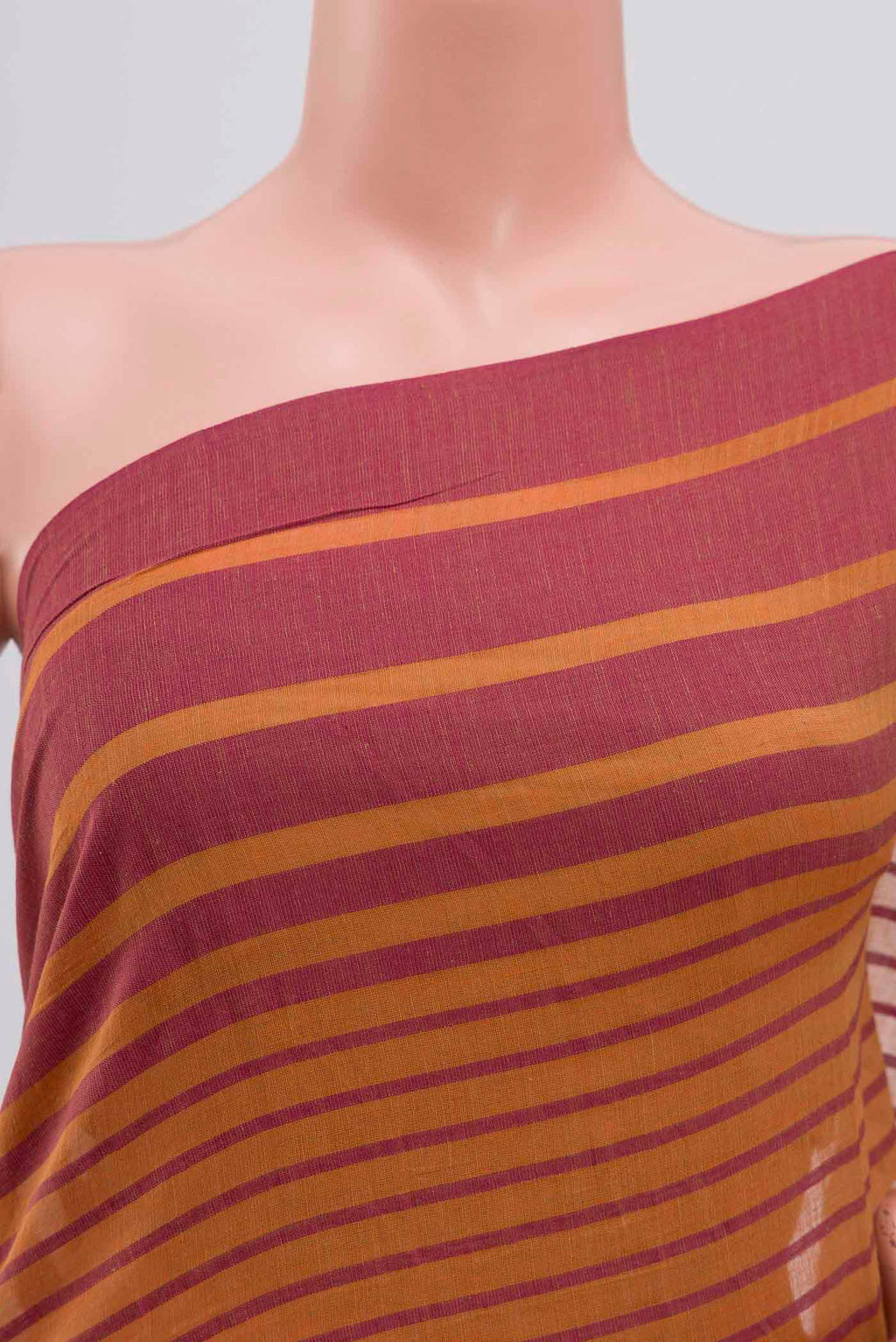 Close up of Titli, framed with proportioned stripes that gradually narrow towards the body, bringing together a vibrant palette in harmony Where the border and pallu stripes meet, tiny checks appear, evoking abstract butterflies - delicate creatures of spring and summer The plain body offers soft contrast, allowing the colours to shine On the pallu, these stripes return as subtle checks, adding a light, balanced finish displaying folds