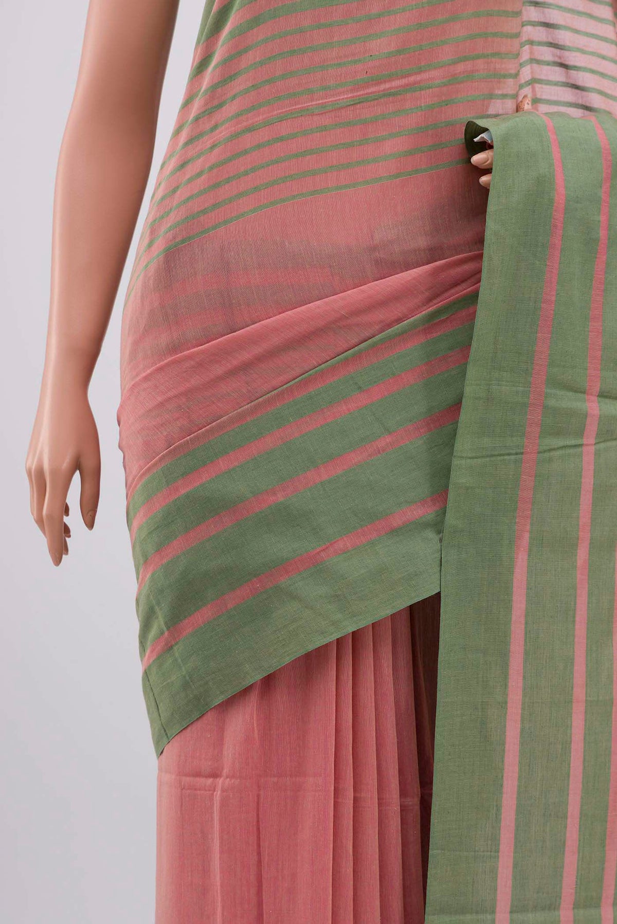 Border image of Titli, framed with proportioned stripes that gradually narrow towards the body, bringing together a vibrant palette in harmony Where the border and pallu stripes meet, tiny checks appear, evoking abstract butterflies - delicate creatures of spring and summer The plain body offers soft contrast, allowing the colours to shine On the pallu, these stripes return as subtle checks, adding a light, balanced finish