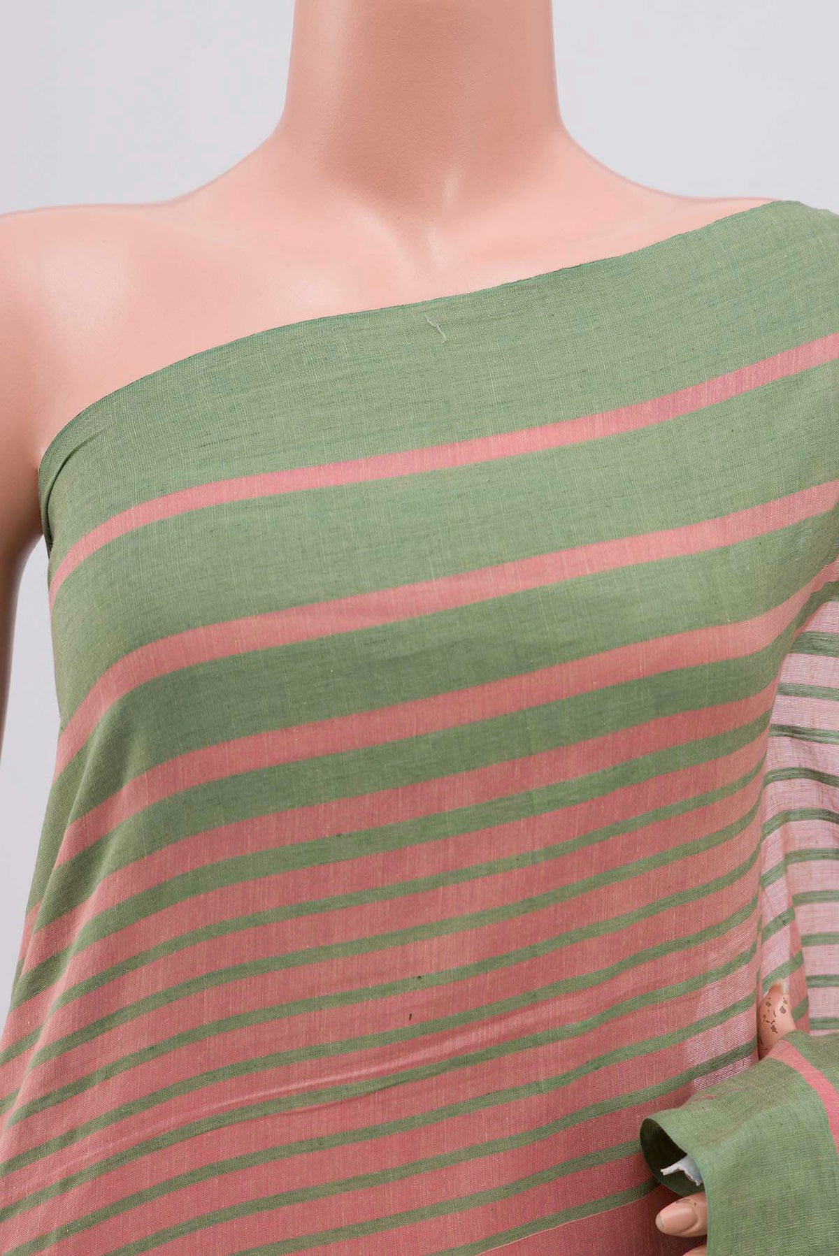 Close up of Titli, framed with proportioned stripes that gradually narrow towards the body, bringing together a vibrant palette in harmony Where the border and pallu stripes meet, tiny checks appear, evoking abstract butterflies - delicate creatures of spring and summer The plain body offers soft contrast, allowing the colours to shine On the pallu, these stripes return as subtle checks, adding a light, balanced finish displaying folds