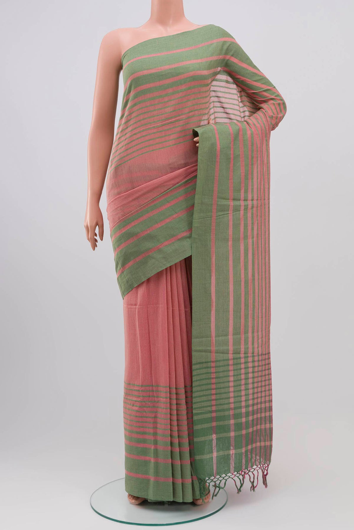 Titli, framed with proportioned stripes that gradually narrow towards the body, bringing together a vibrant palette in harmony Where the border and pallu stripes meet, tiny checks appear, evoking abstract butterflies - delicate creatures of spring and summer The plain body offers soft contrast, allowing the colours to shine On the pallu, these stripes return as subtle checks, adding a light, balanced finish displayed on a mannequin