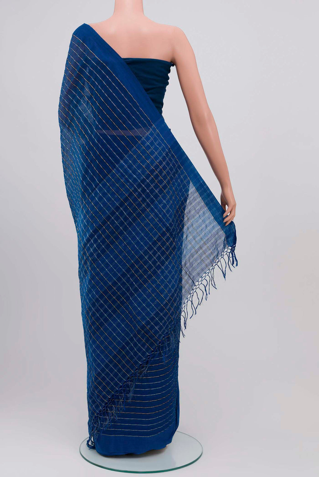 Pleats and pallu of Mishri, a celebration of summer in Bengal cotton, is woven in fine 60-count cotton and drapes with natural comfort Soft stripes move in gentle linear patterns across the fabric, creating a lively yet balanced design The fine checks they form are a gentle reminder of crystal sugar, lending the saree its name Light, breathable, and effortlessly wearable for sunlit days