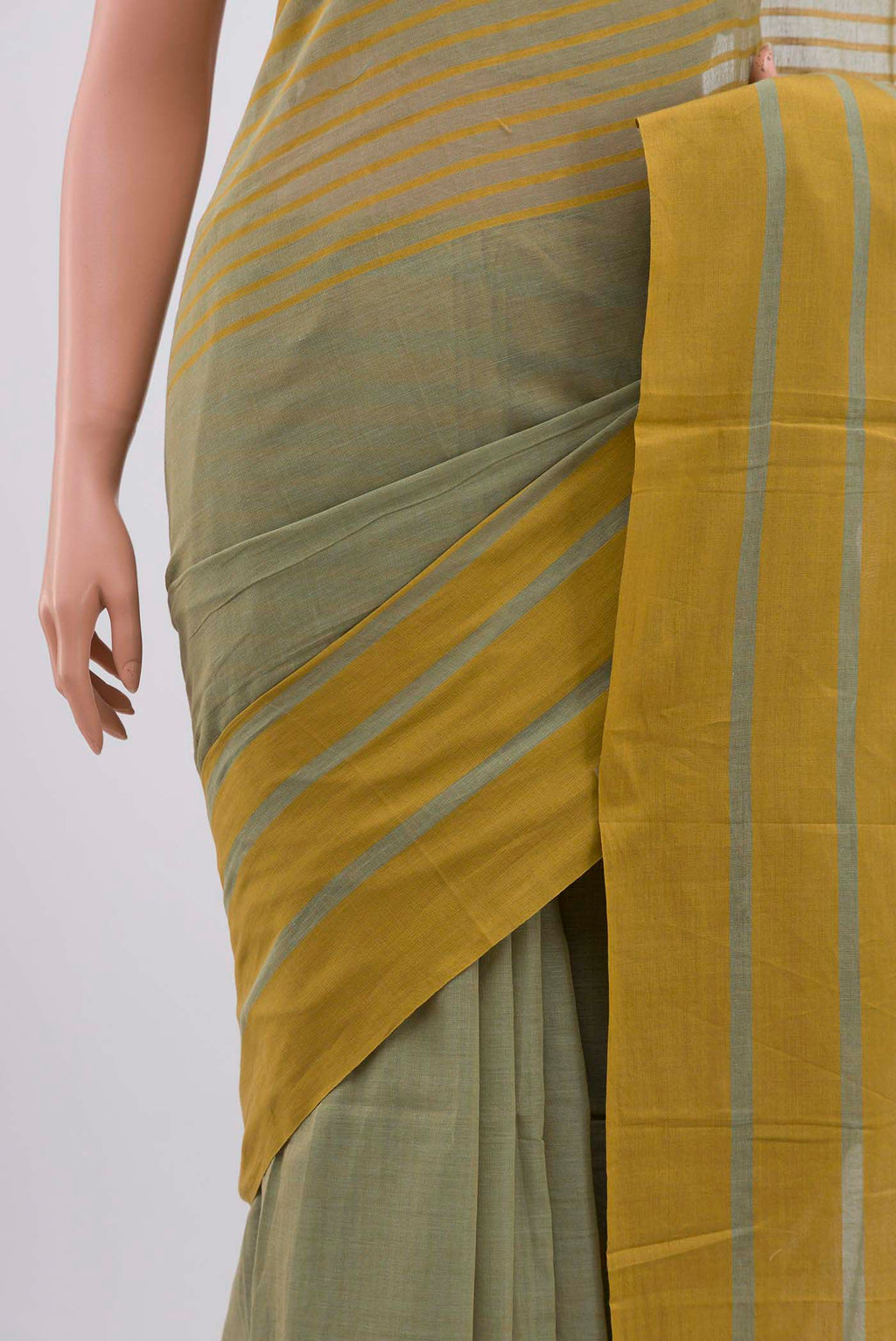 Border image of Titli, framed with proportioned stripes that gradually narrow towards the body, bringing together a vibrant palette in harmony Where the border and pallu stripes meet, tiny checks appear, evoking abstract butterflies - delicate creatures of spring and summer The plain body offers soft contrast, allowing the colours to shine On the pallu, these stripes return as subtle checks, adding a light, balanced finish