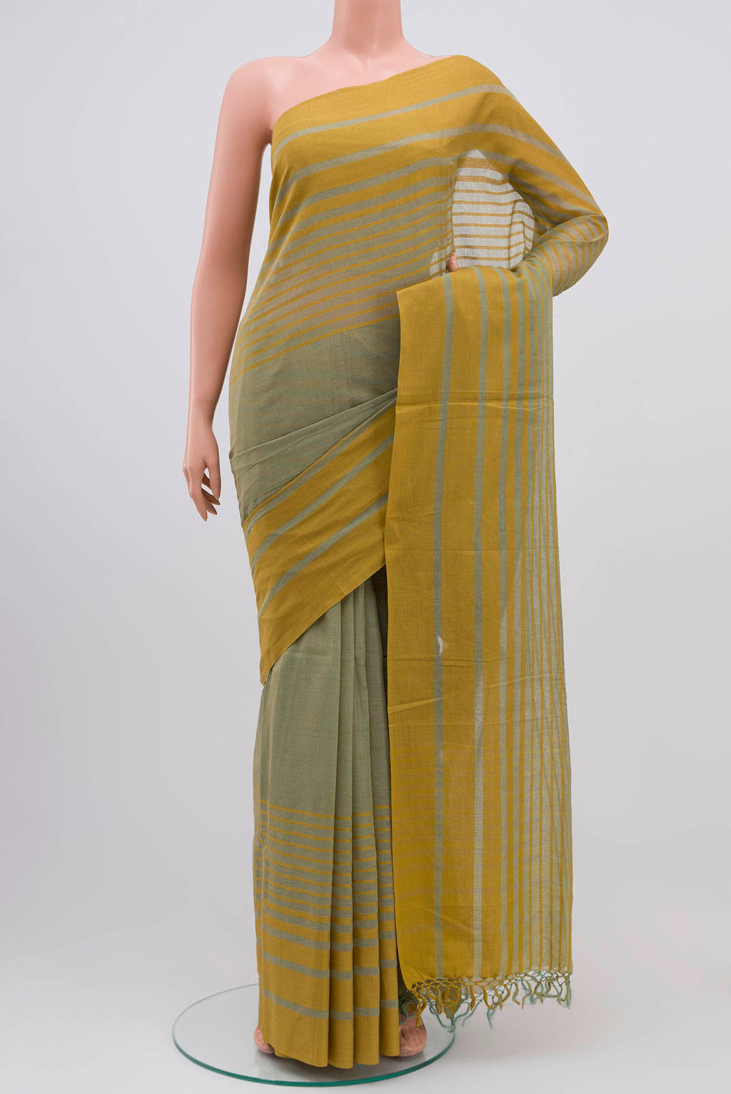 Titli, framed with proportioned stripes that gradually narrow towards the body, bringing together a vibrant palette in harmony Where the border and pallu stripes meet, tiny checks appear, evoking abstract butterflies - delicate creatures of spring and summer The plain body offers soft contrast, allowing the colours to shine On the pallu, these stripes return as subtle checks, adding a light, balanced finish displayed on a mannequin