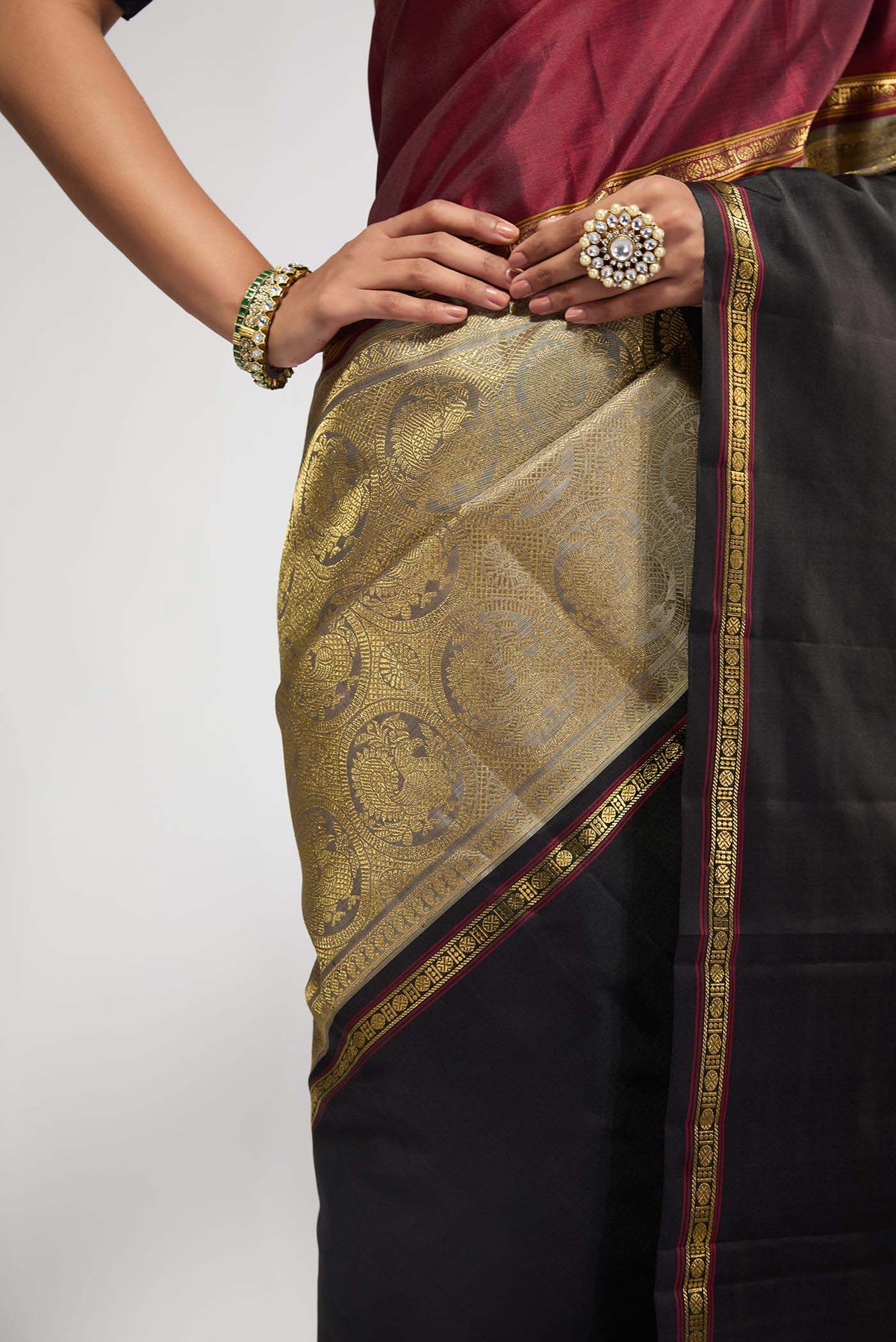 Close up of Pure Silk Pure Zari Grey Kanchipuram Saree with Zari Brocade on the body and Ganga Jamuna Border displaying folds