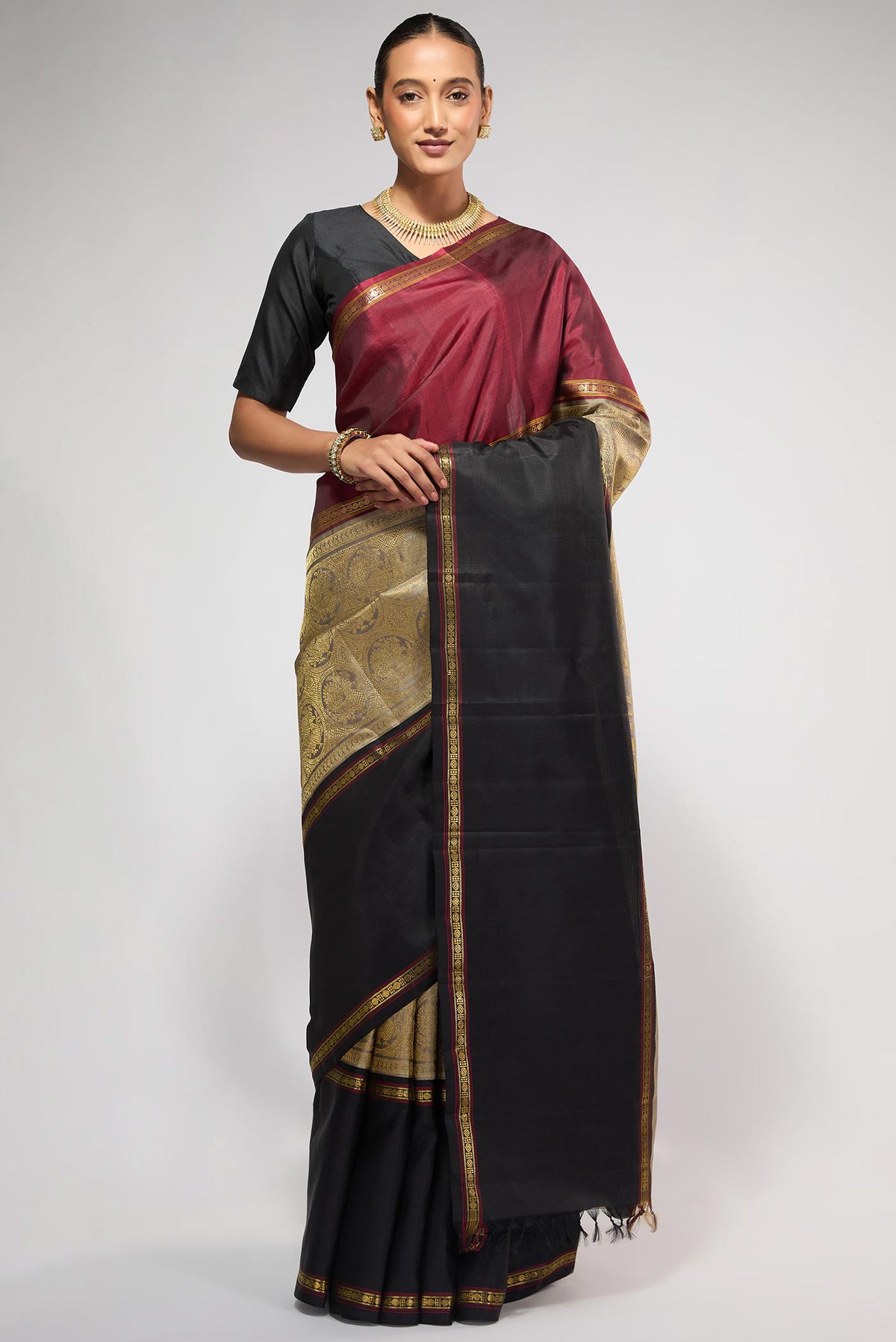 Pure Silk Pure Zari Grey Kanchipuram Saree with Zari Brocade on the body and Ganga Jamuna Border displayed on a mannequin