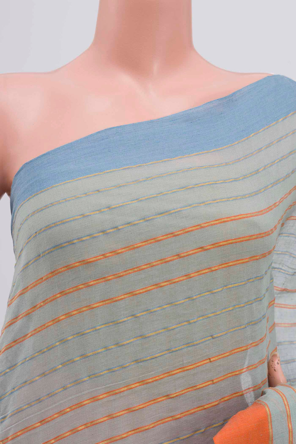 Close up of Mishri, a celebration of summer in Bengal cotton, is woven in fine 60-count cotton and drapes with natural comfort Soft stripes move in gentle linear patterns across the fabric, creating a lively yet balanced design The fine checks they form are a gentle reminder of crystal sugar, lending the saree its name Light, breathable, and effortlessly wearable for sunlit days displaying folds