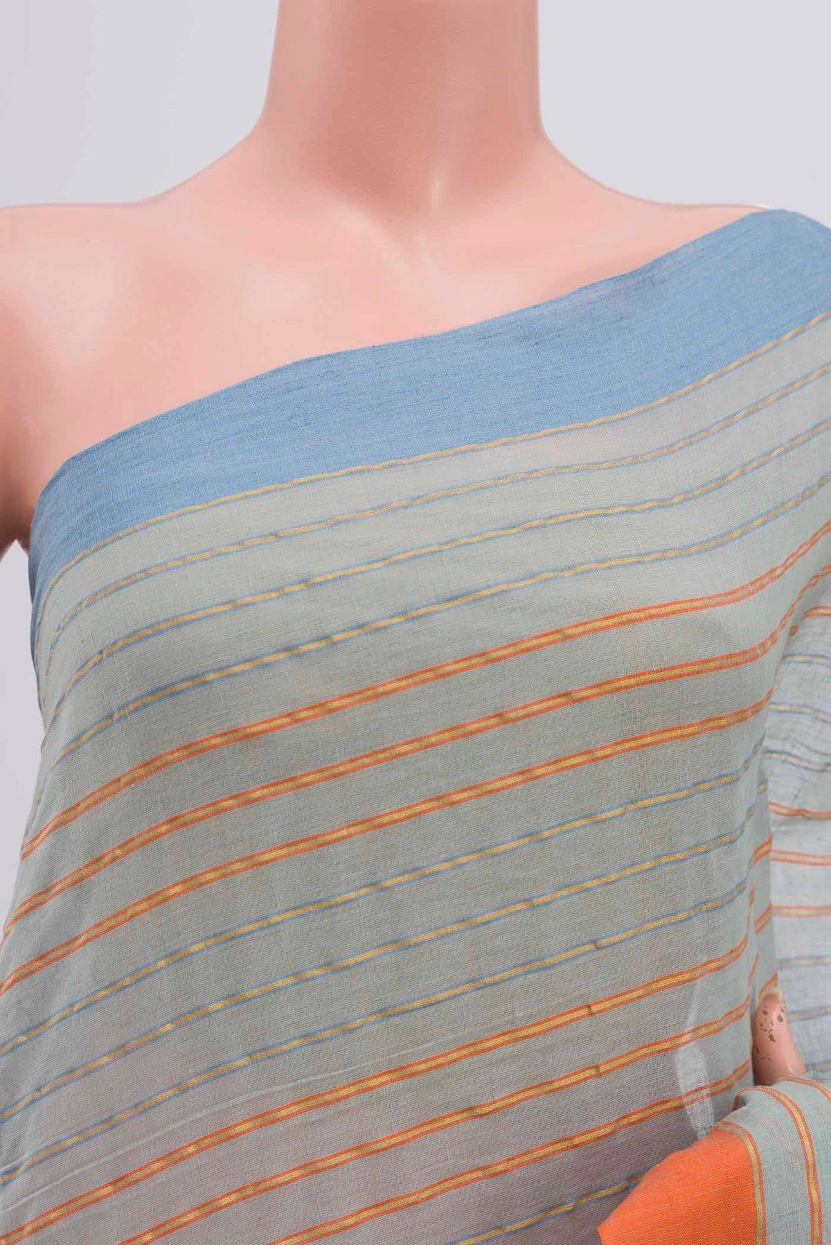 Close up of Mishri, a celebration of summer in Bengal cotton, is woven in fine 60-count cotton and drapes with natural comfort Soft stripes move in gentle linear patterns across the fabric, creating a lively yet balanced design The fine checks they form are a gentle reminder of crystal sugar, lending the saree its name Light, breathable, and effortlessly wearable for sunlit days displaying folds