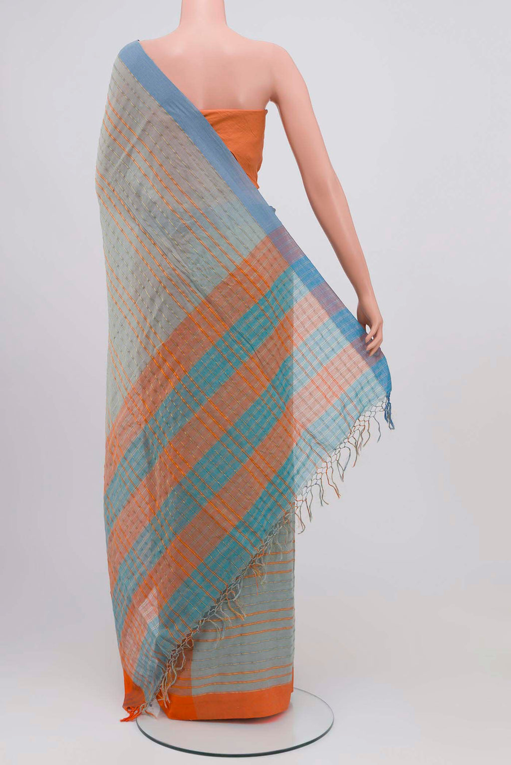 Pleats and pallu of Mishri, a celebration of summer in Bengal cotton, is woven in fine 60-count cotton and drapes with natural comfort Soft stripes move in gentle linear patterns across the fabric, creating a lively yet balanced design The fine checks they form are a gentle reminder of crystal sugar, lending the saree its name Light, breathable, and effortlessly wearable for sunlit days