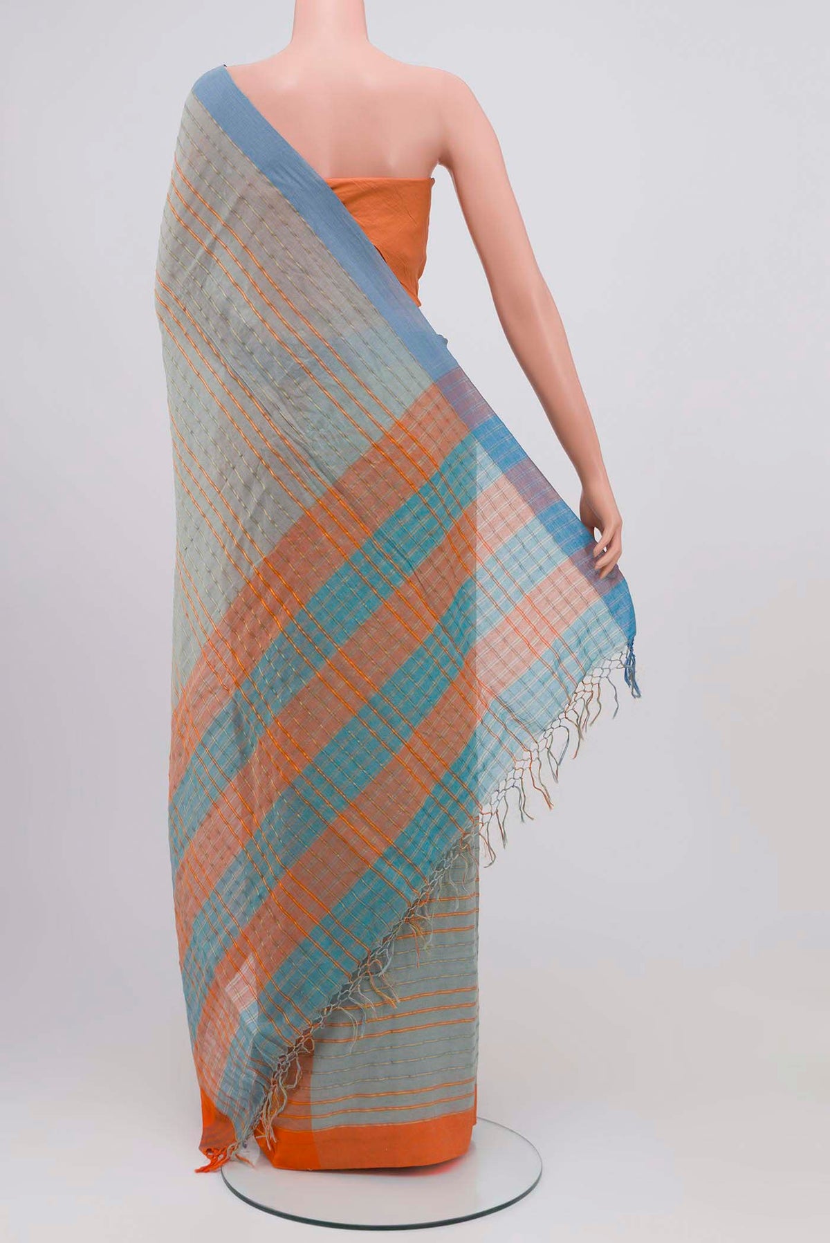 Pleats and pallu of Mishri, a celebration of summer in Bengal cotton, is woven in fine 60-count cotton and drapes with natural comfort Soft stripes move in gentle linear patterns across the fabric, creating a lively yet balanced design The fine checks they form are a gentle reminder of crystal sugar, lending the saree its name Light, breathable, and effortlessly wearable for sunlit days