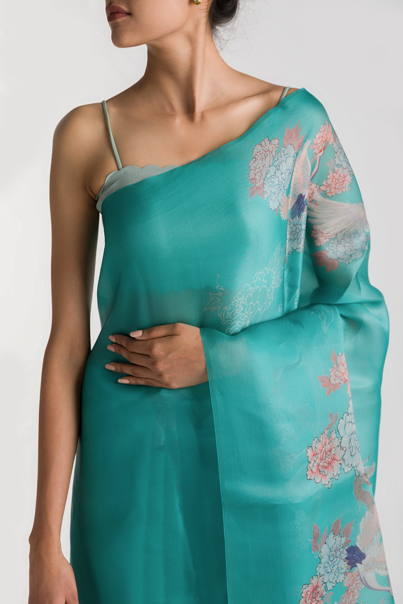 Close up of Light Blue Satin Organza Saree with Bird Print on the body and Without Border displaying folds
