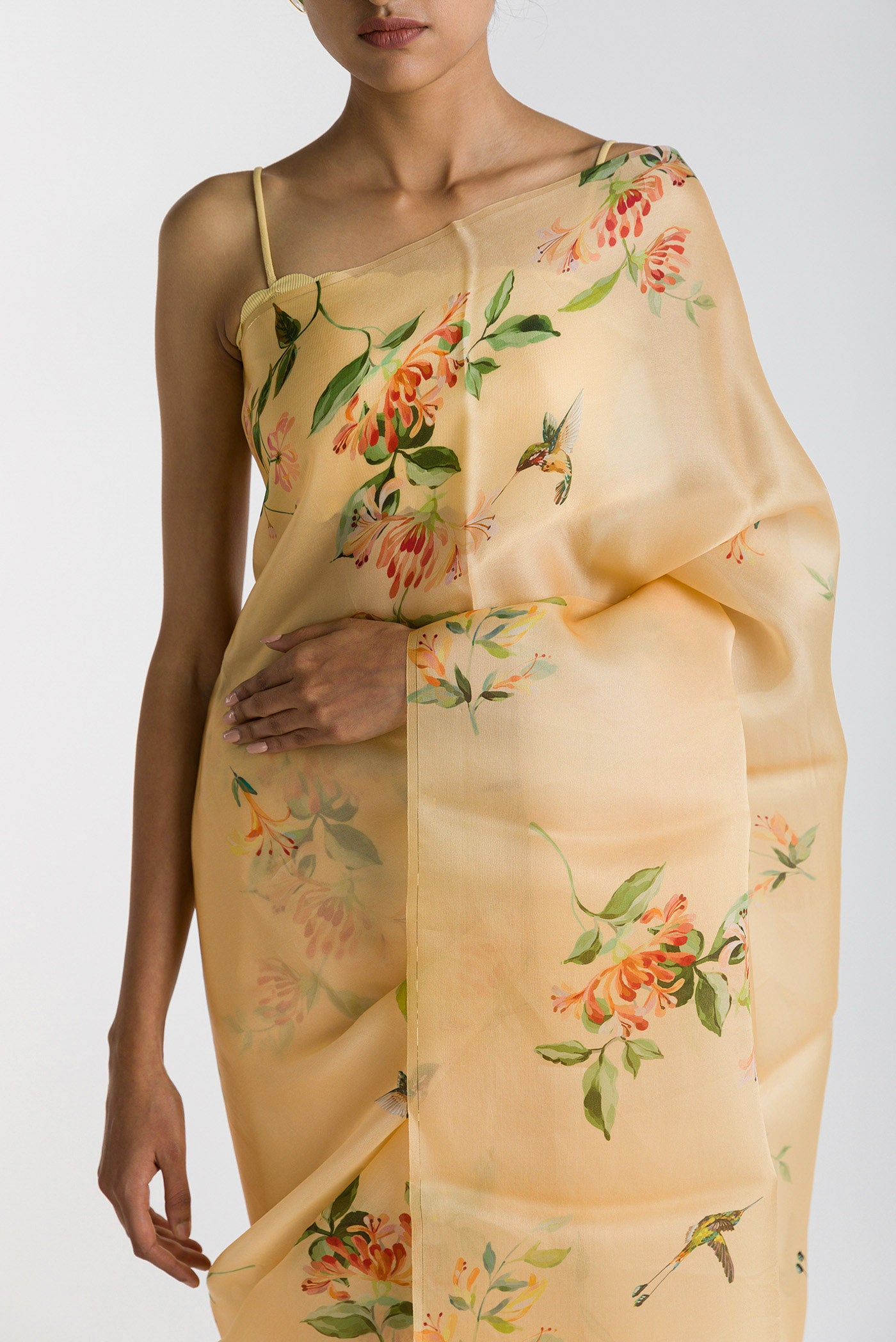 Close up of Yellow Satin Organza Saree with Bird Print on the body and Without Border displaying folds