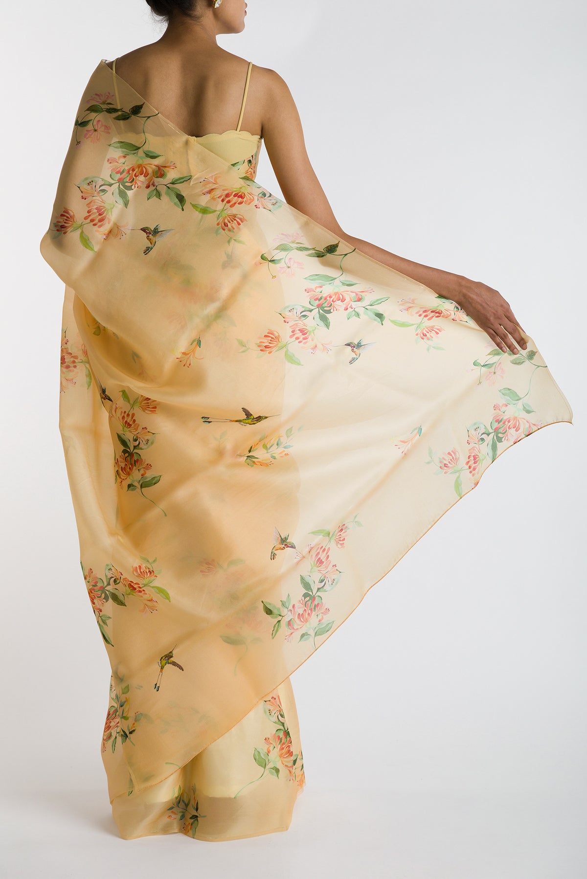 Pleats and pallu of Yellow Satin Organza Saree with Bird Print on the body and Without Border