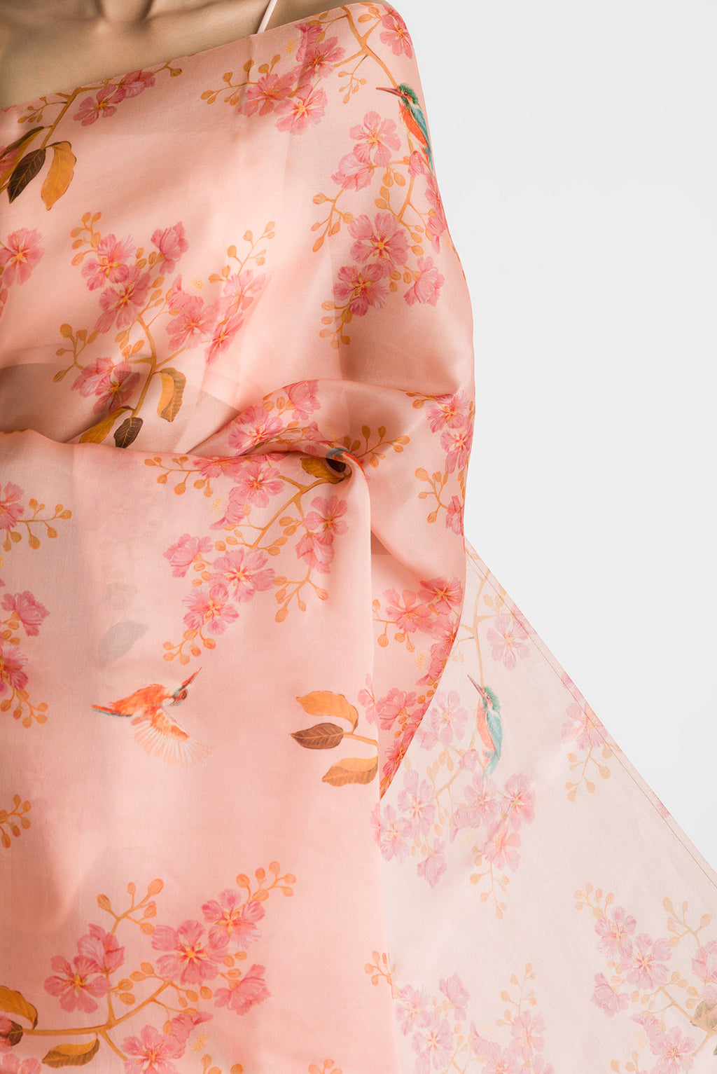 Close up of Peach Satin Organza Saree with Bird Print on the body and Without Border displaying folds