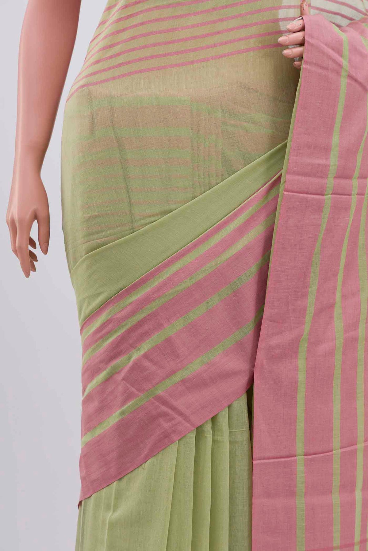 Border image of Titli, framed with proportioned stripes that gradually narrow towards the body, bringing together a vibrant palette in harmony Where the border and pallu stripes meet, tiny checks appear, evoking abstract butterflies - delicate creatures of spring and summer The plain body offers soft contrast, allowing the colours to shine On the pallu, these stripes return as subtle checks, adding a light, balanced finish