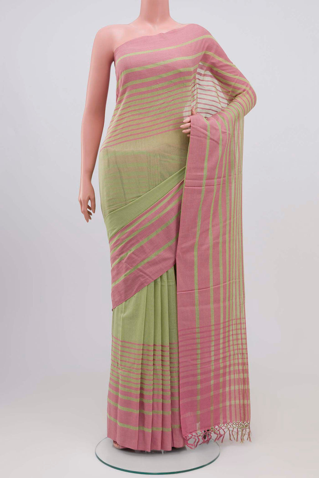 Titli, framed with proportioned stripes that gradually narrow towards the body, bringing together a vibrant palette in harmony Where the border and pallu stripes meet, tiny checks appear, evoking abstract butterflies - delicate creatures of spring and summer The plain body offers soft contrast, allowing the colours to shine On the pallu, these stripes return as subtle checks, adding a light, balanced finish displayed on a mannequin