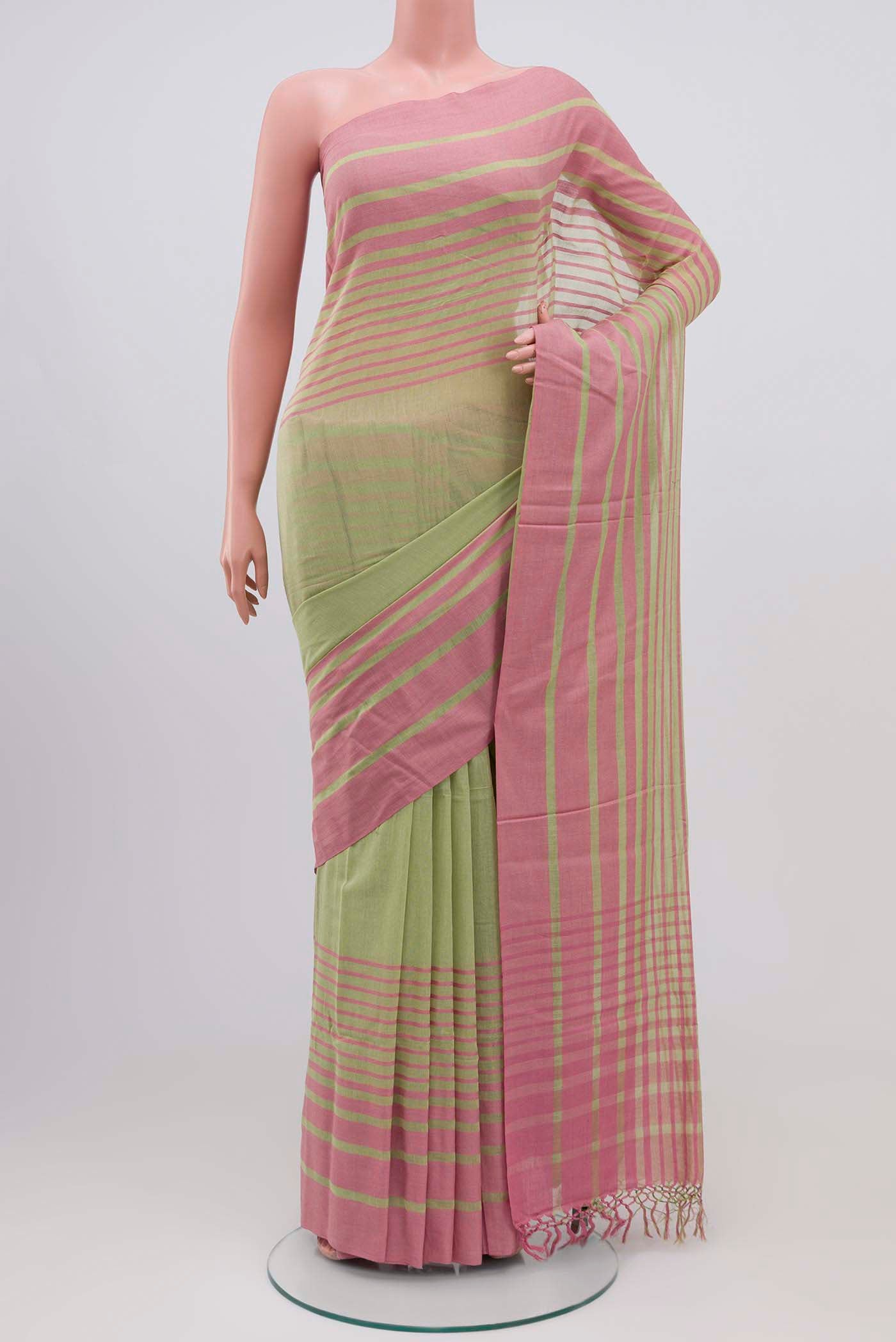 Titli, framed with proportioned stripes that gradually narrow towards the body, bringing together a vibrant palette in harmony Where the border and pallu stripes meet, tiny checks appear, evoking abstract butterflies - delicate creatures of spring and summer The plain body offers soft contrast, allowing the colours to shine On the pallu, these stripes return as subtle checks, adding a light, balanced finish displayed on a mannequin