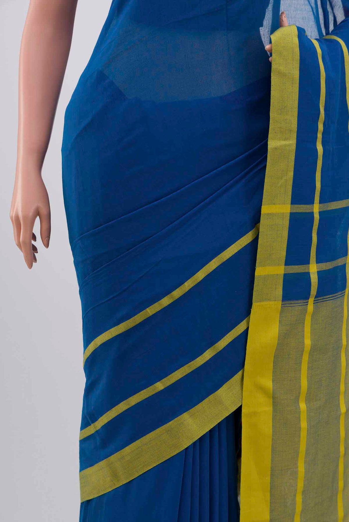 Border image of Chhaya, our Bengal cotton saree, draws inspiration from the clean, modern lines of Piet Mondrian A contrasting band forms the top border, creating a striking visual highlight across the body, while minimal stripes along the base and pallu introduce structure and balance Bold colour blocks reinterpret Chhaya, meaning shadow in Hindi, and the solid pallu completes the look with contemporary ease