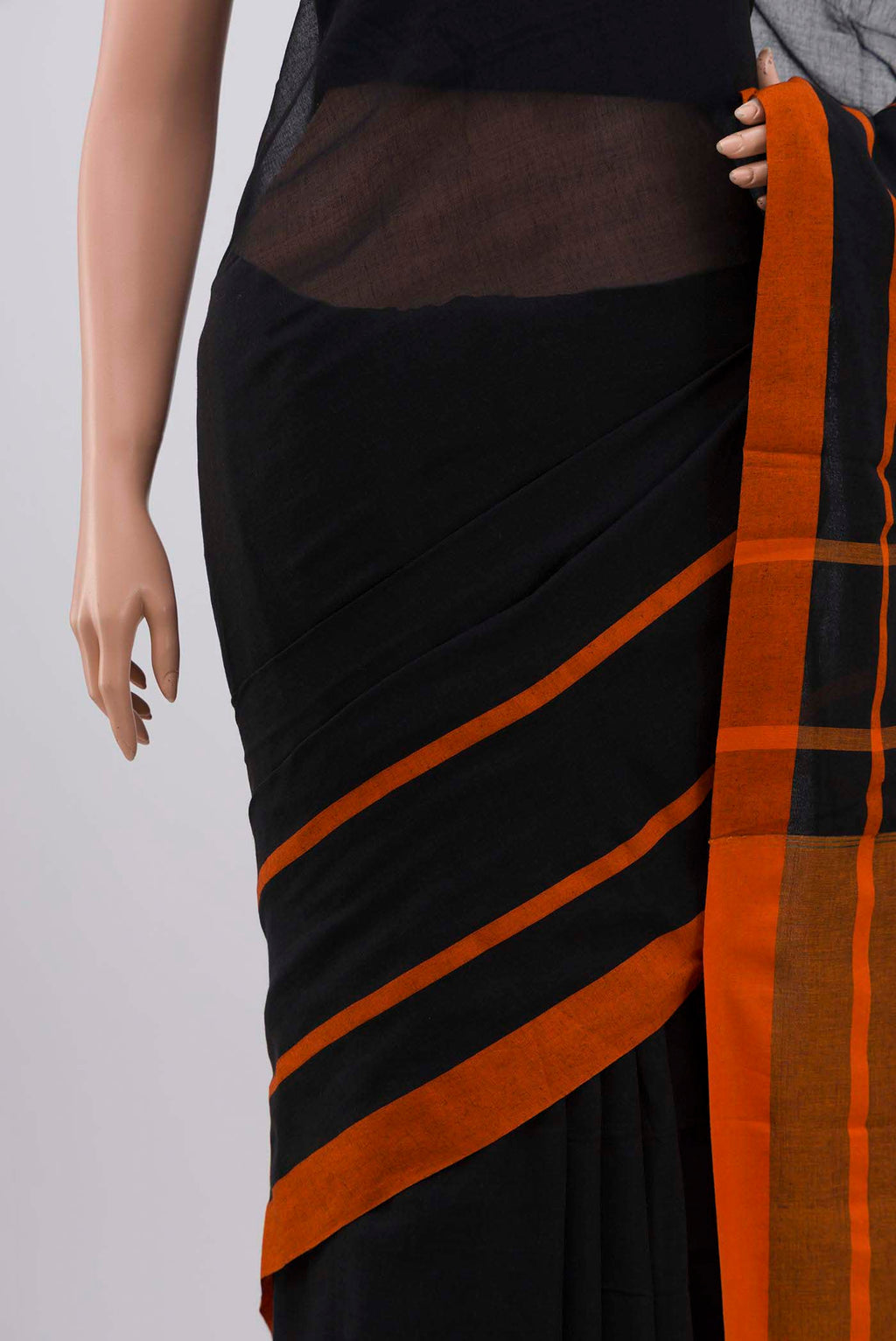 Border image of Chhaya, our Bengal cotton saree, draws inspiration from the clean, modern lines of Piet Mondrian A contrasting band forms the top border, creating a striking visual highlight across the body, while minimal stripes along the base and pallu introduce structure and balance Bold colour blocks reinterpret Chhaya, meaning shadow in Hindi, and the solid pallu completes the look with contemporary ease