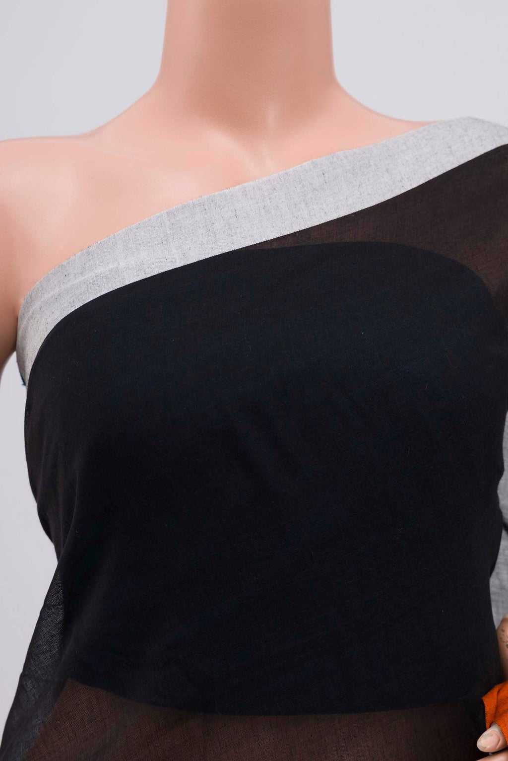Close up of Chhaya, our Bengal cotton saree, draws inspiration from the clean, modern lines of Piet Mondrian A contrasting band forms the top border, creating a striking visual highlight across the body, while minimal stripes along the base and pallu introduce structure and balance Bold colour blocks reinterpret Chhaya, meaning shadow in Hindi, and the solid pallu completes the look with contemporary ease displaying folds