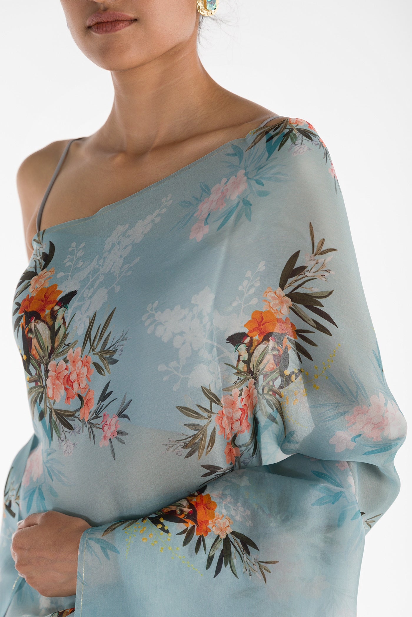 Close up of Blue Satin Organza Saree with Bird Print on the body and Without Border displaying folds