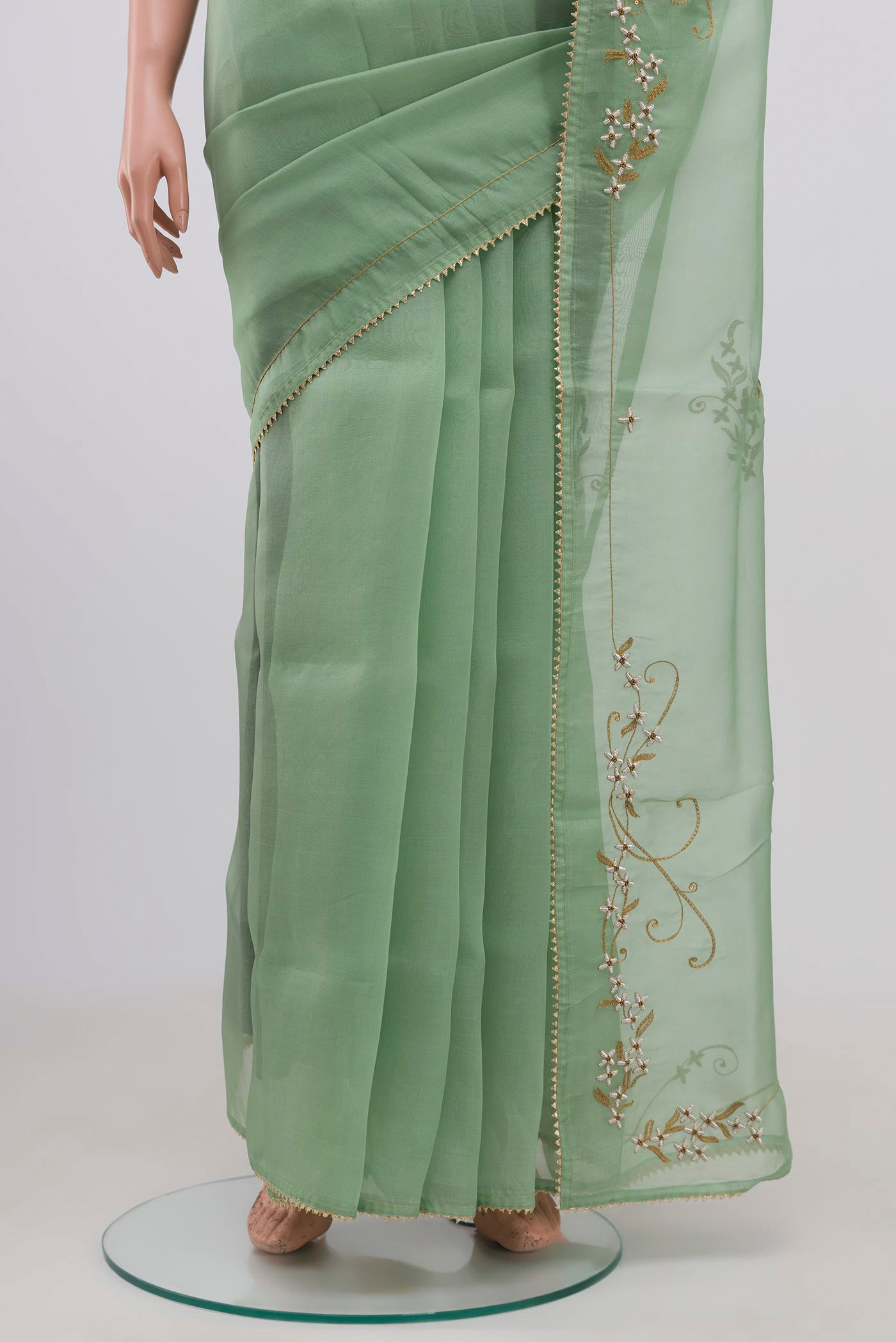 Pleats and pallu of Green Organza Silk Saree with Embroidery on the body and Embroidery Border