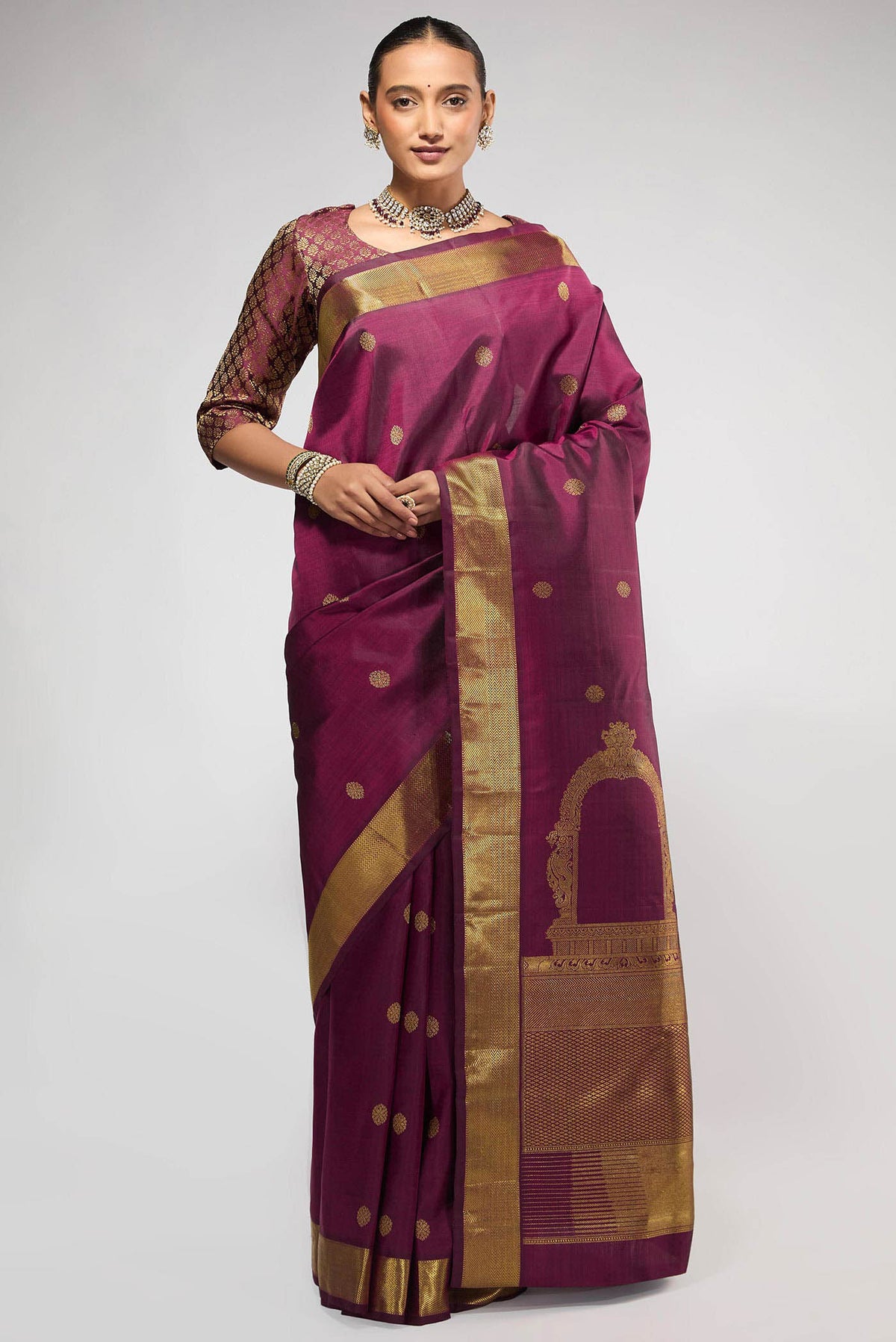 Pure Silk Pure Zari Maroon Kanchipuram Saree with Zari Butta on the body and Zari Border displayed on a mannequin