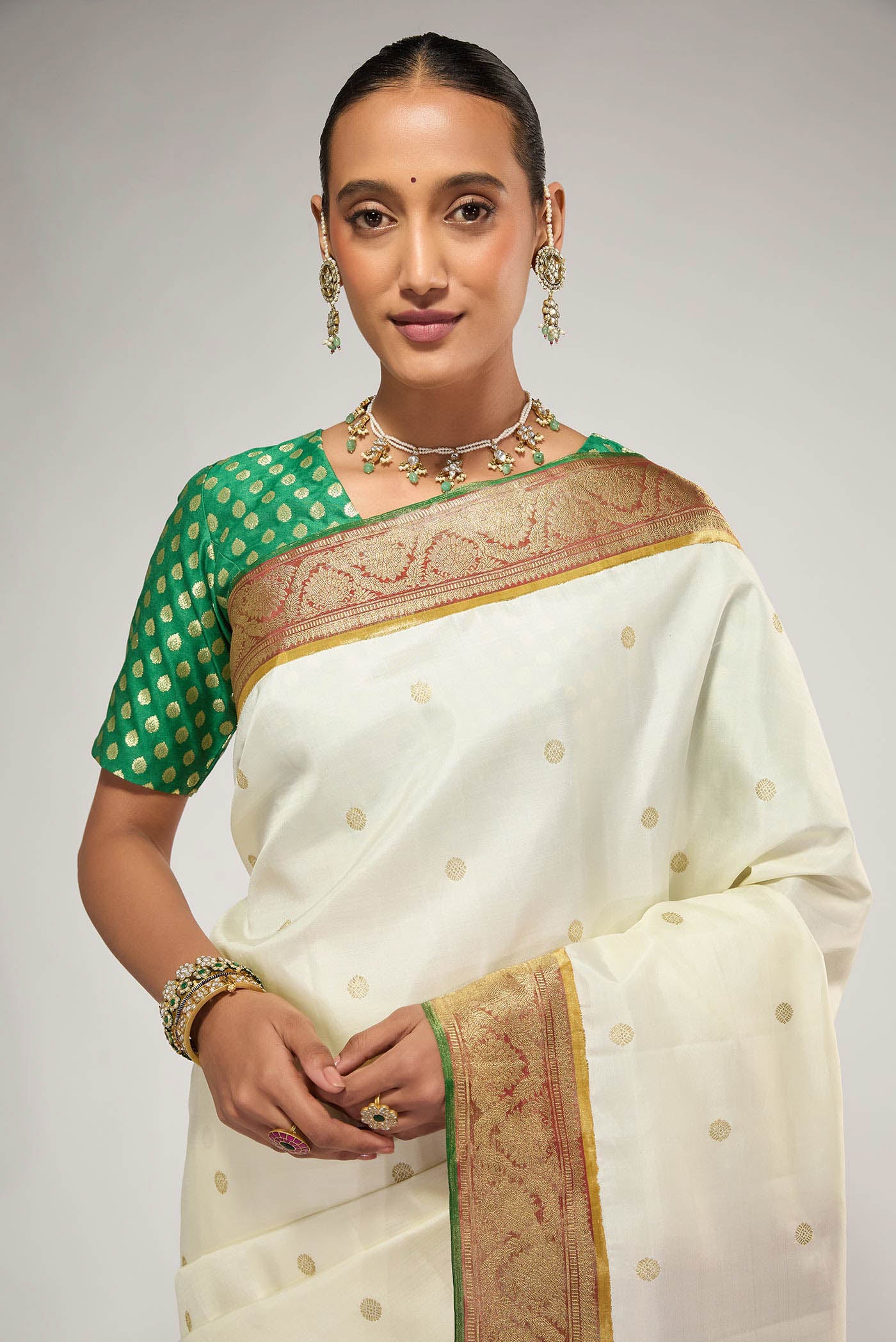 Close up image of the blouse of Pure Silk Pure Zari Off White Kanchipuram Saree with Zari Butta on the body and Zari Border