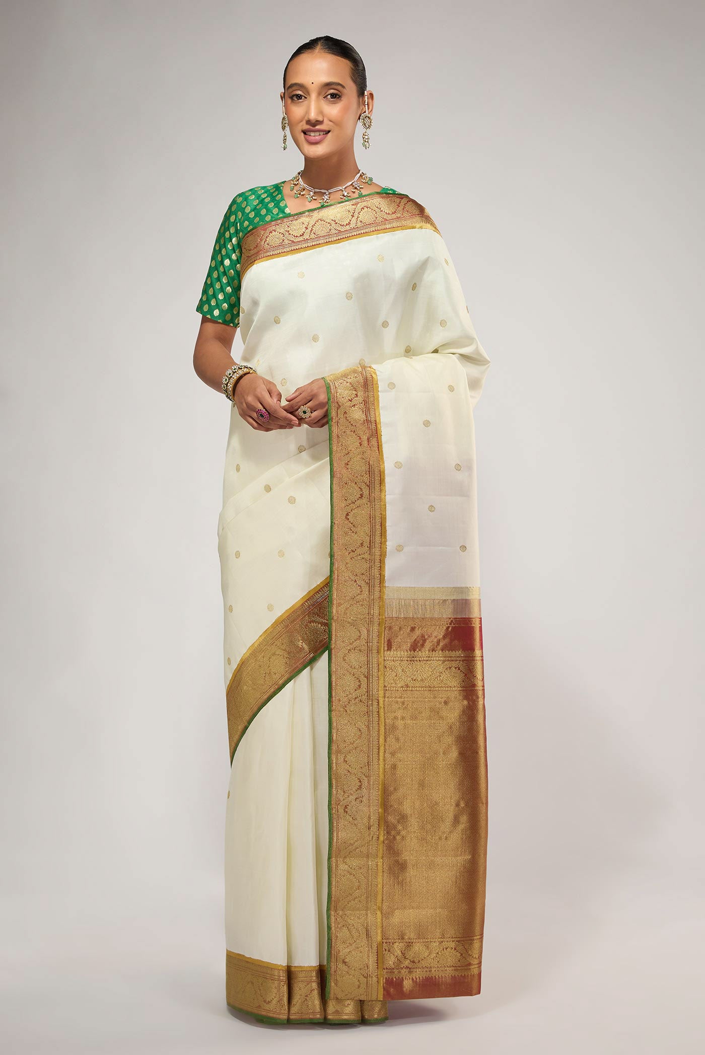 Pure Silk Pure Zari Off White Kanchipuram Saree with Zari Butta on the body and Zari Border displayed on a mannequin