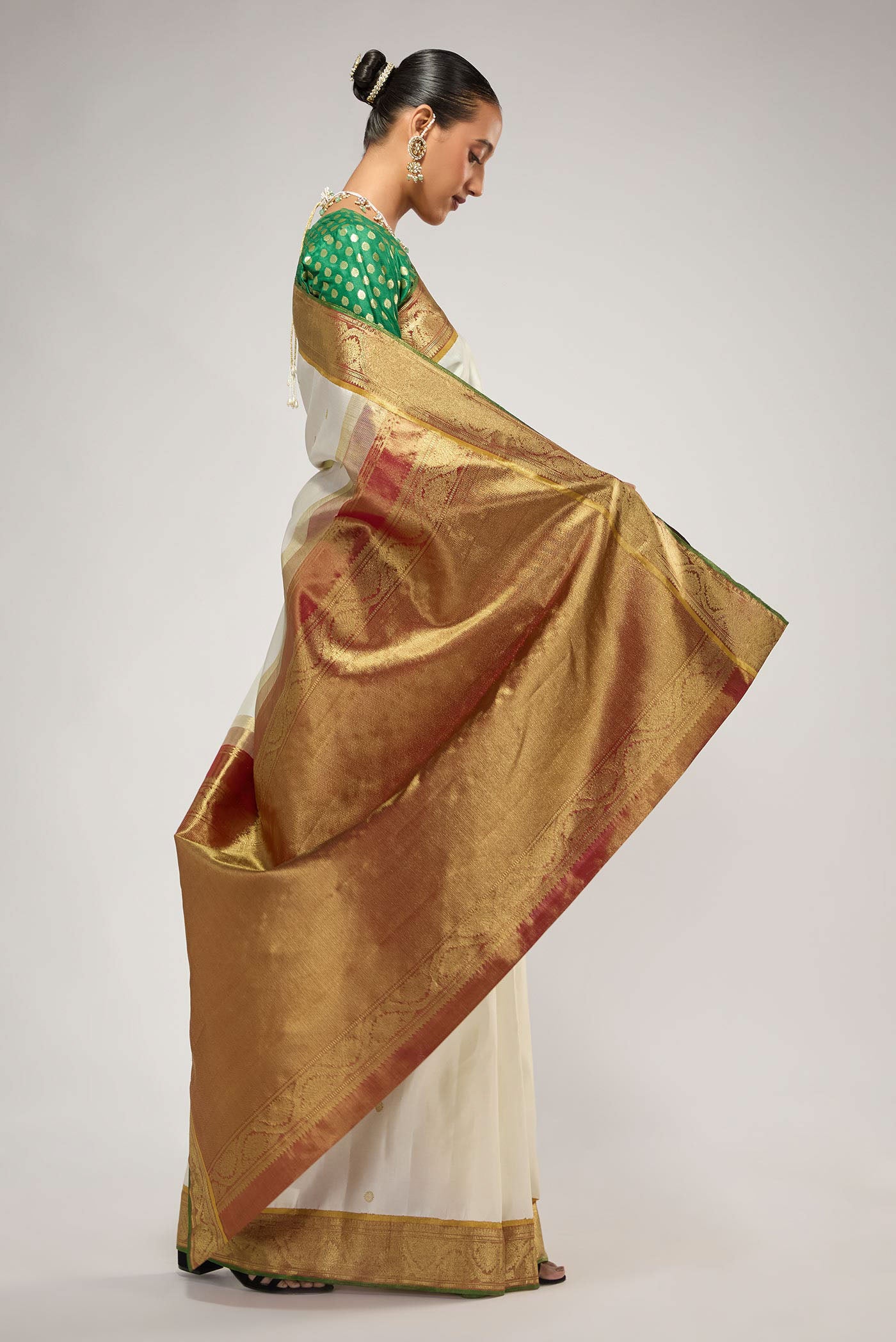 Close up image of the pallu of Pure Silk Pure Zari Off White Kanchipuram Saree with Zari Butta on the body and Zari Border