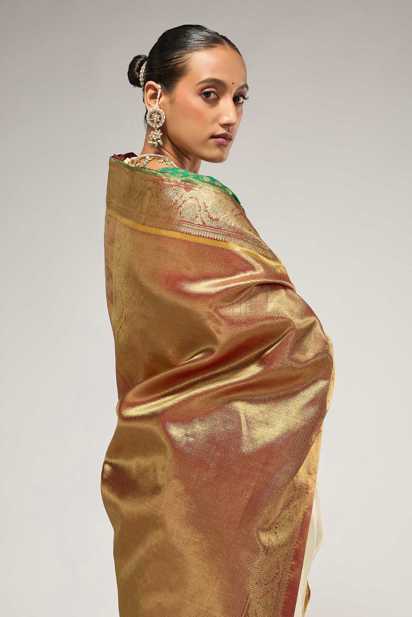 Flat view of Pure Silk Pure Zari Off White Kanchipuram Saree with Zari Butta on the body and Zari Border